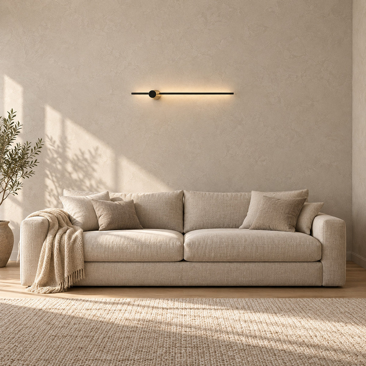 Semarlo black and gold hardwired wall light glowing above a sofa in a living room by day