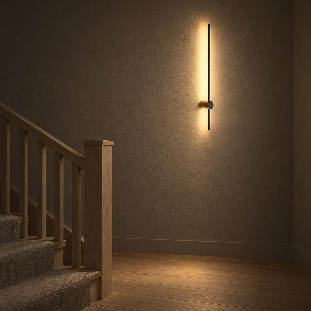 Semarlo black and gold LED wall sconce lighting a stair landing at night with a long warm glow
