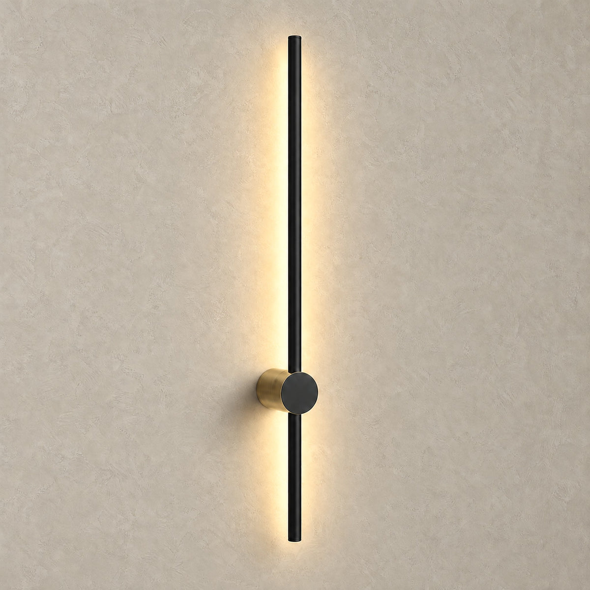 Semarlo black and gold LED wall sconce lit against a plain backdrop, casting a soft warm halo