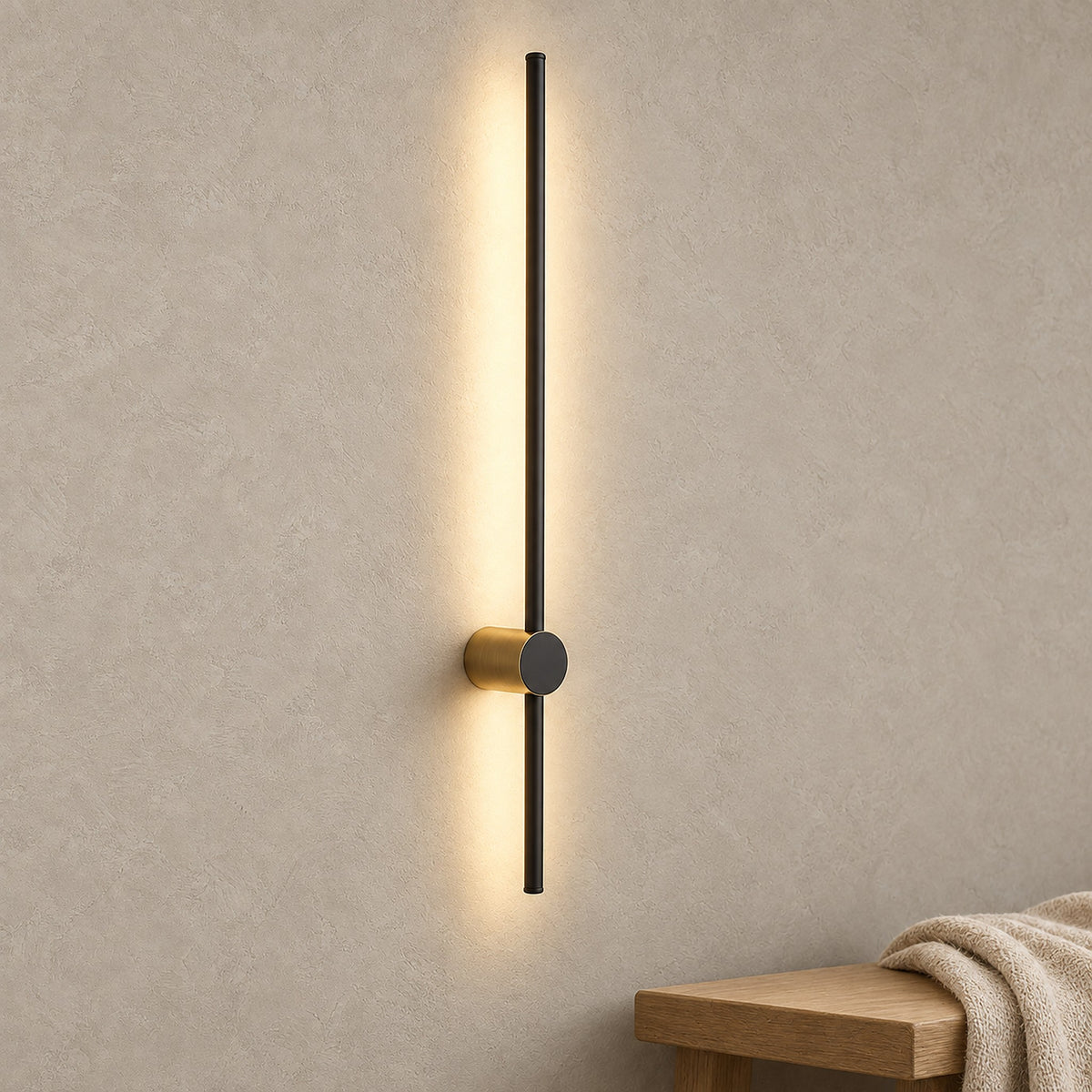 Semarlo black and gold wall light glowing warm along the wall of a bright entry vestibule by day