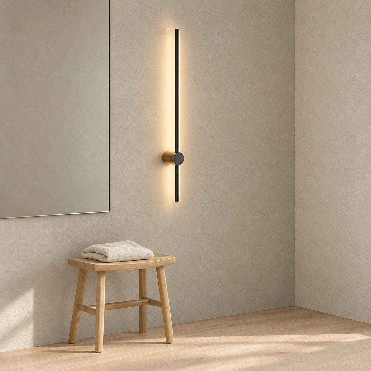 Semarlo black and gold wall light switched on beside a dressing room mirror in daytime