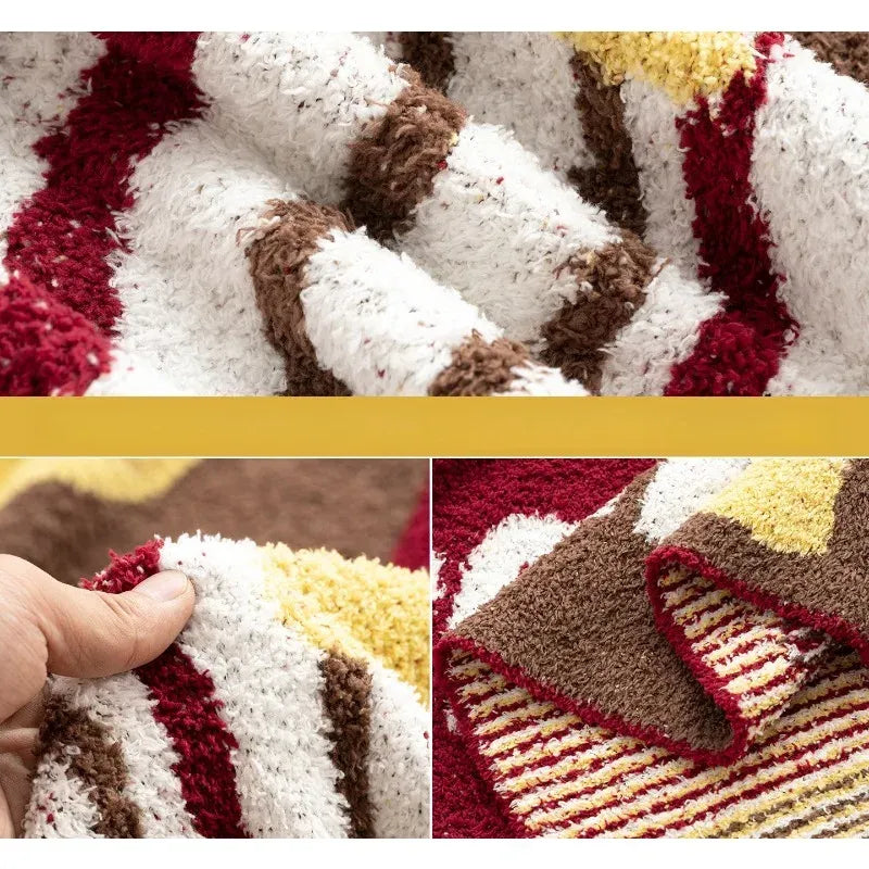 Senalio christmas fleece throw blanket in close ups showing fluffy red, white, brown and yellow folds and a hand held edge