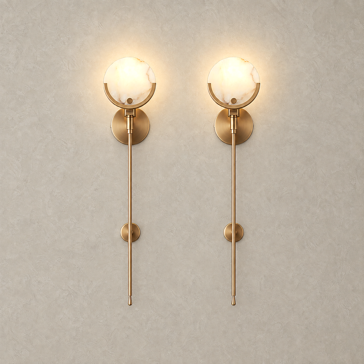 Serrinte brass wall sconce set of 2 lit side by side, pale stone discs on brass cradles and stems