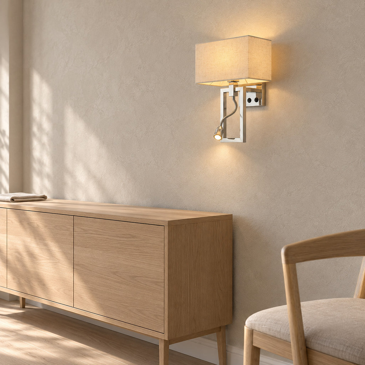 Silarno chrome wall lamp with a white fabric shade lit beside dining room furniture