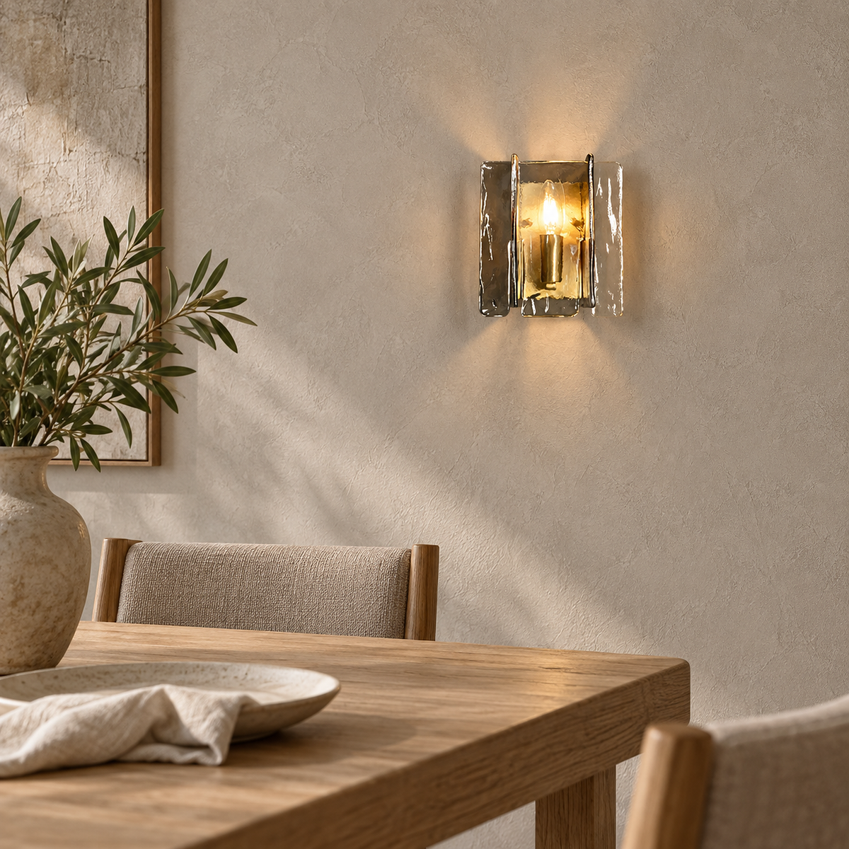 Simaelo black wall lamp lit above dining room furniture with plaster seen through its clear glass