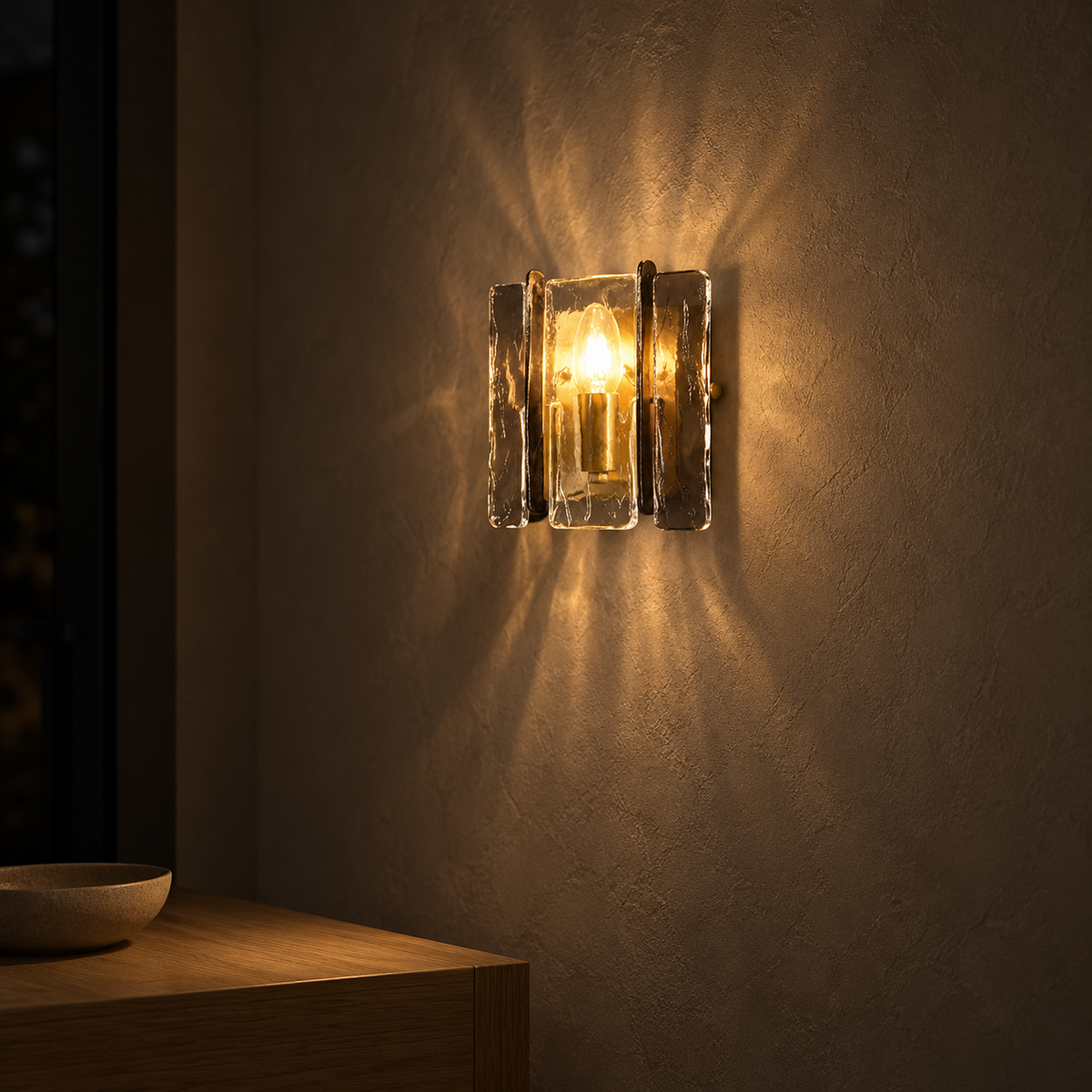 Simaelo black wall sconce casting warm light in an entryway after dark