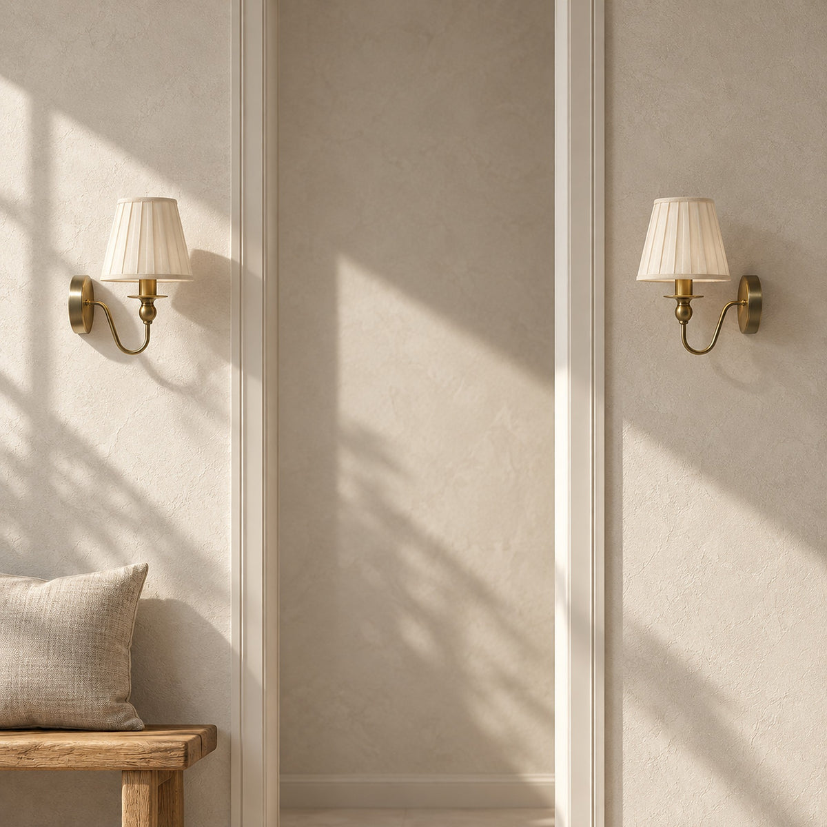 Siralto gold wall lamp pair switched off and flanking a sunlit entry doorway