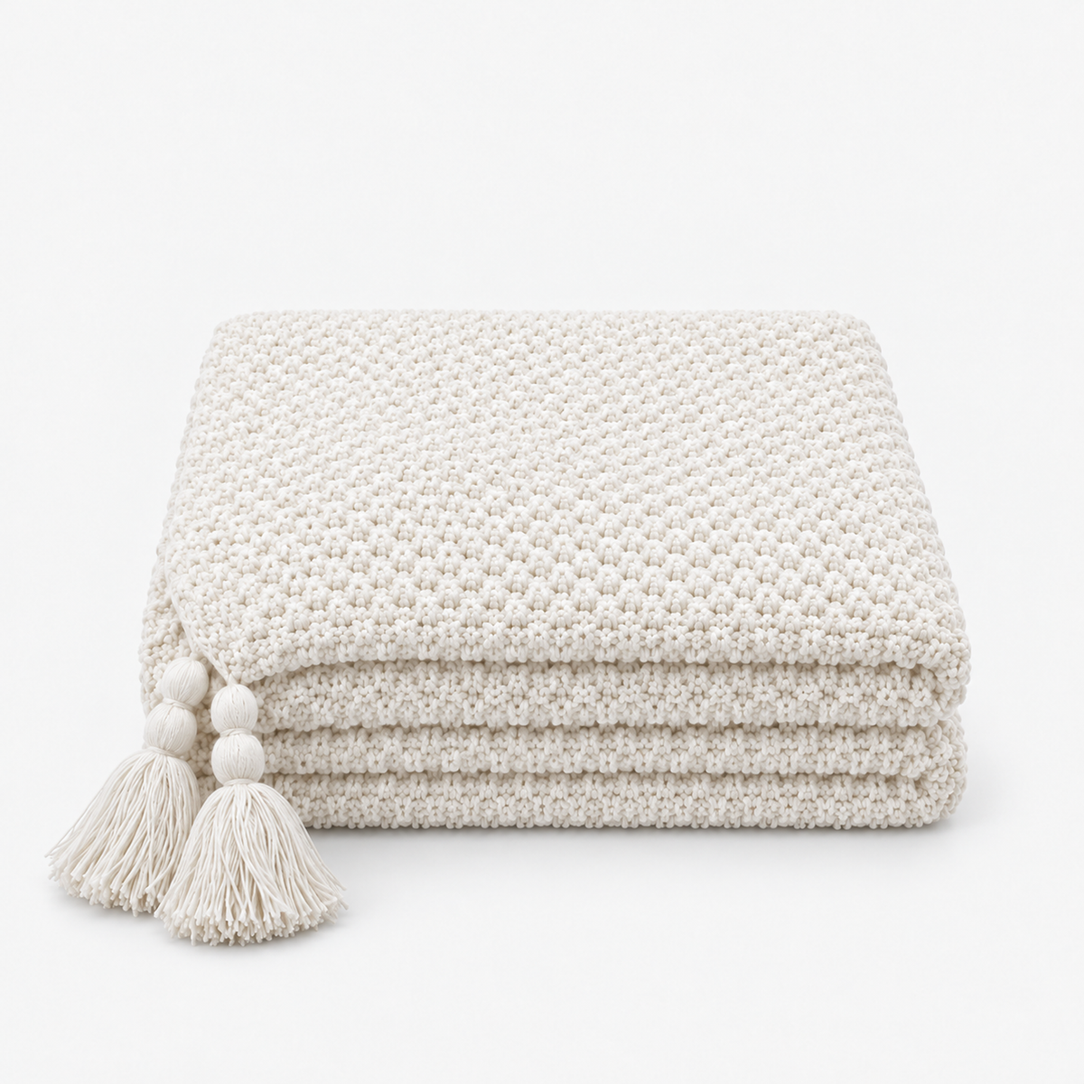 Soralvi white knit throw blanket folded to show its small raised stitches and plain solid color #color_white