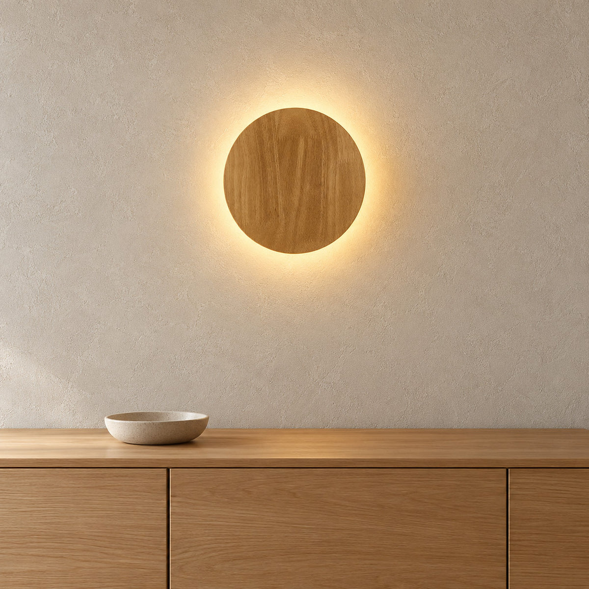 Sorivan light brown LED wall sconce with a wood grain face and warm light around its perimeter