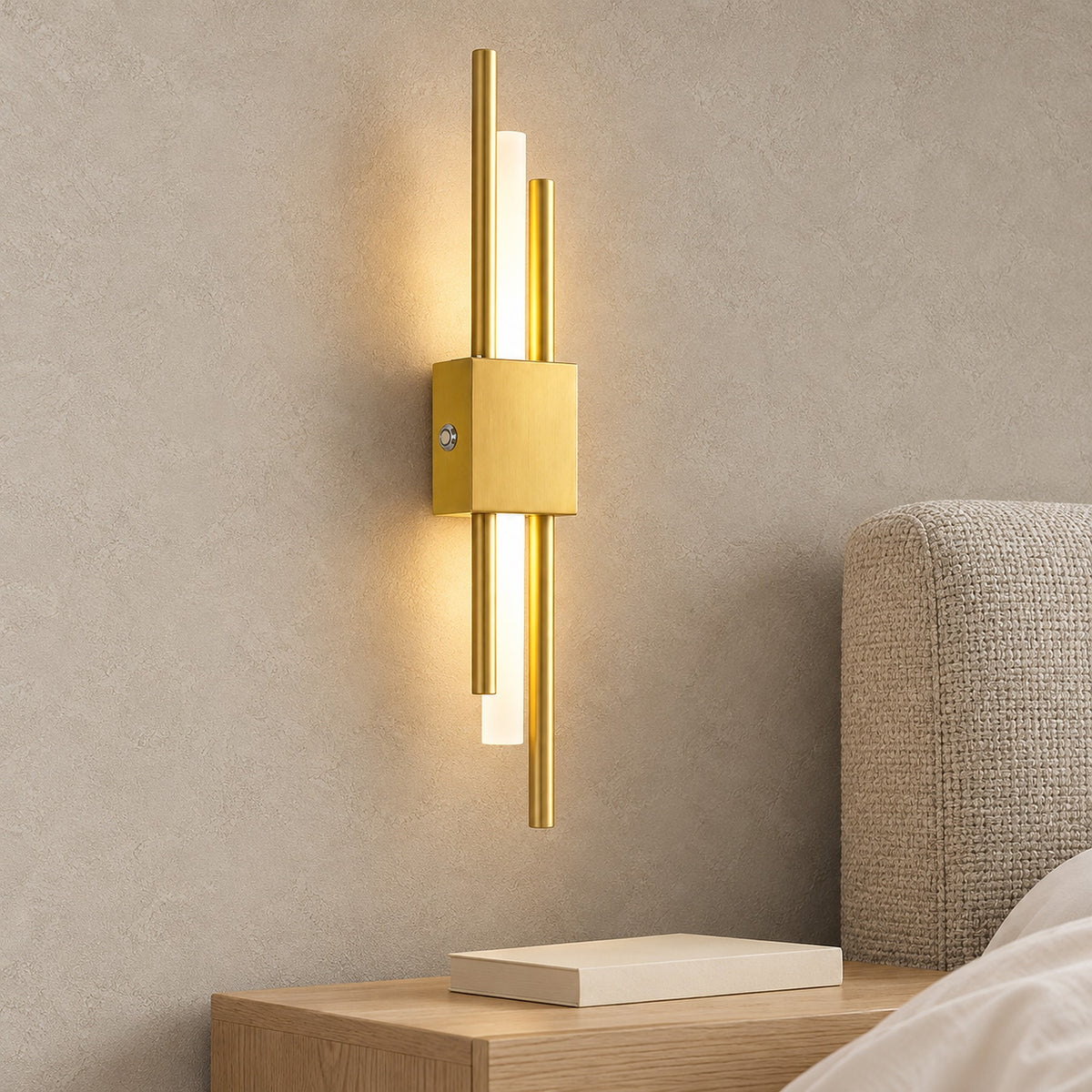 Sorlimo gold and white cordless wall lamp lit beside a bedroom headboard in daylight