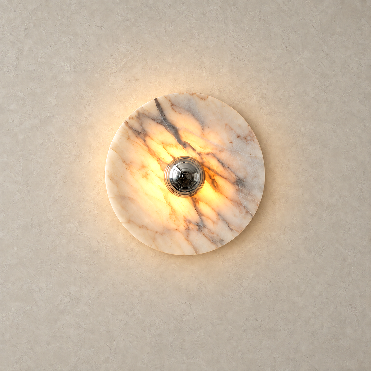 Talemio chrome marble wall sconce lit with a warm halo on the plaster behind it