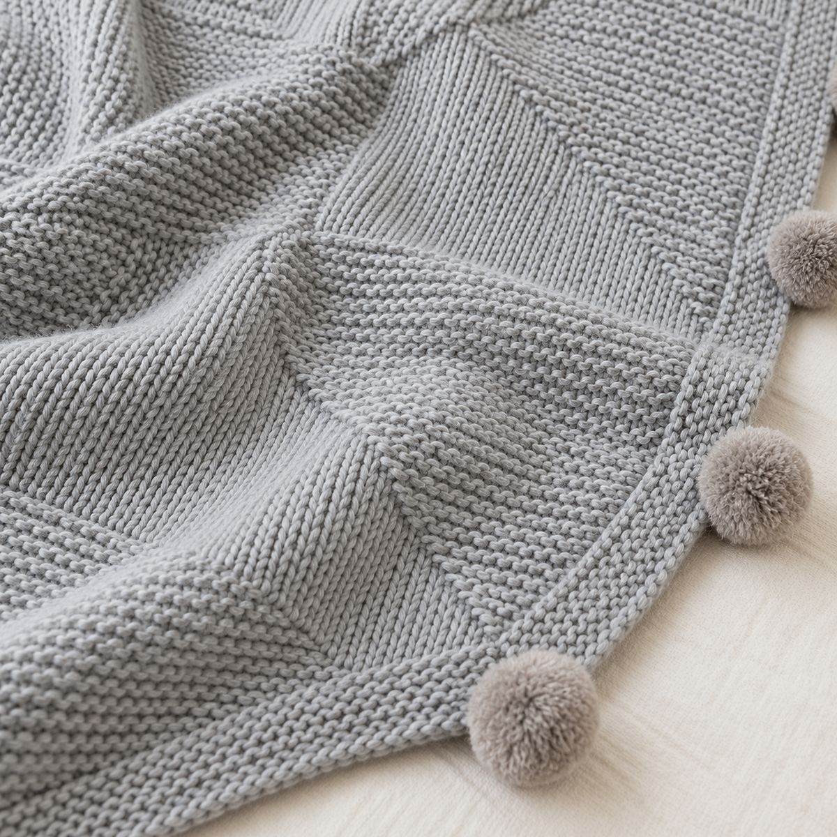 Talenvo knit throw blanket in light gray, close view of the knit panels and woven texture