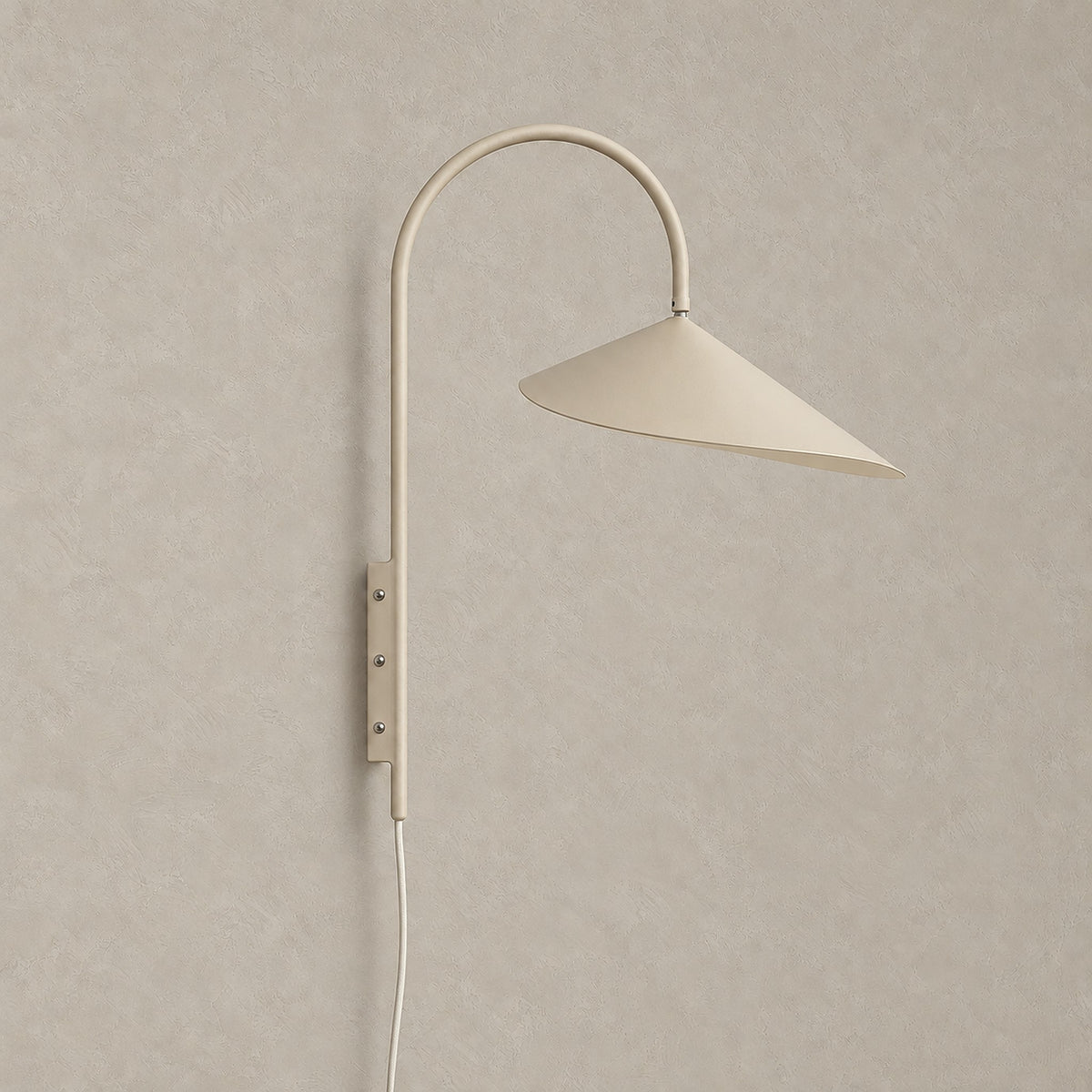 Talirsa beige plug in wall sconce, unlit, shown on its own against plaster #color_beige