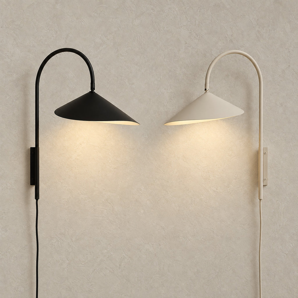 Talirsa black and beige wall sconce options, both switched on and shown side by side