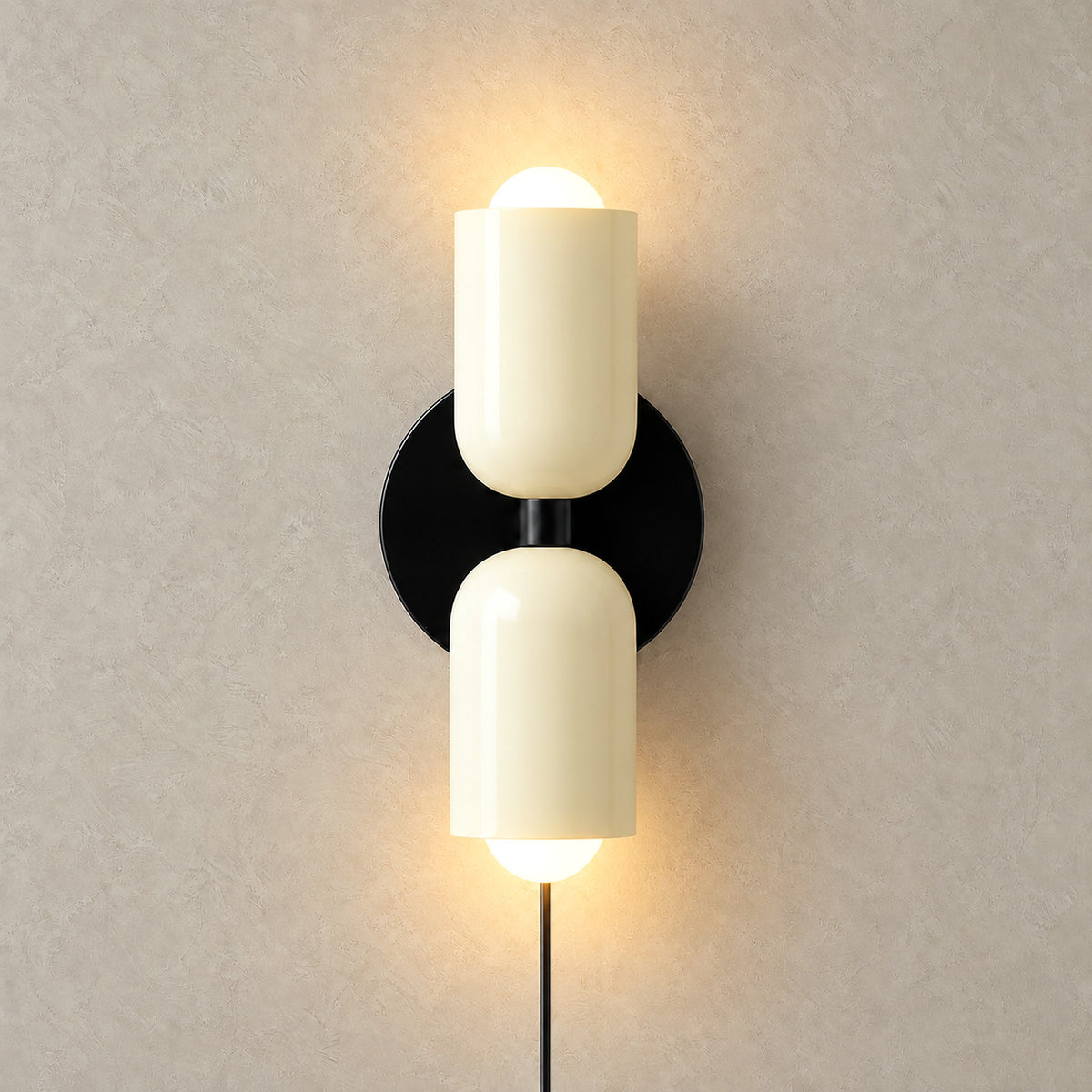 Talomi beige plug in wall light illuminated in a front view with both heads lit
