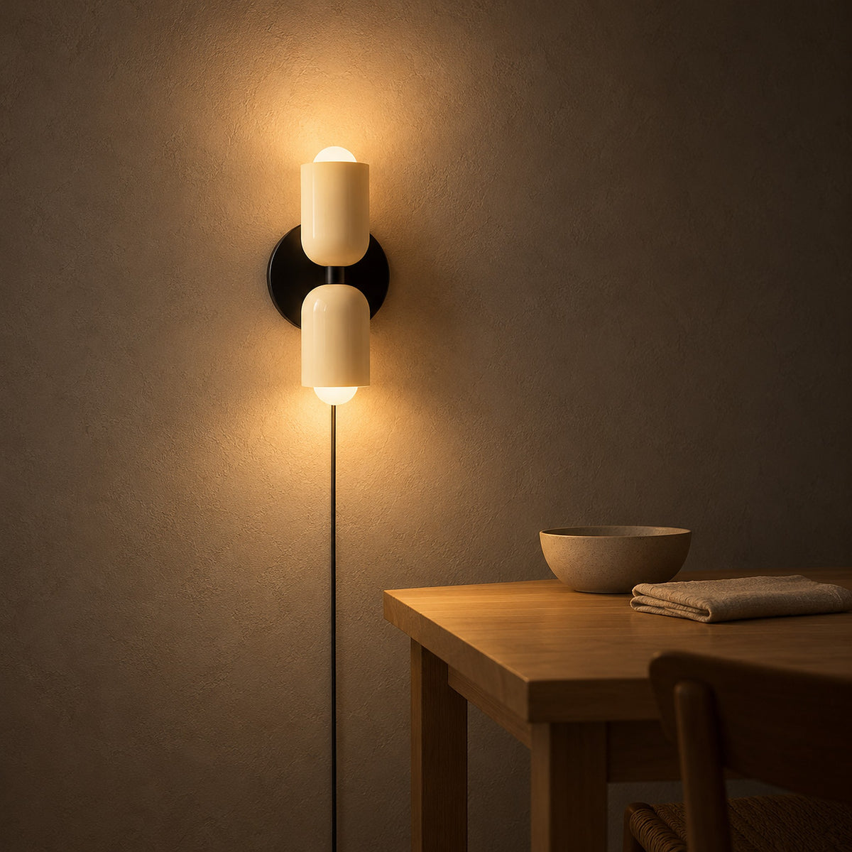 Talomi beige plug in wall sconce casting warm light beside an evening dining setting