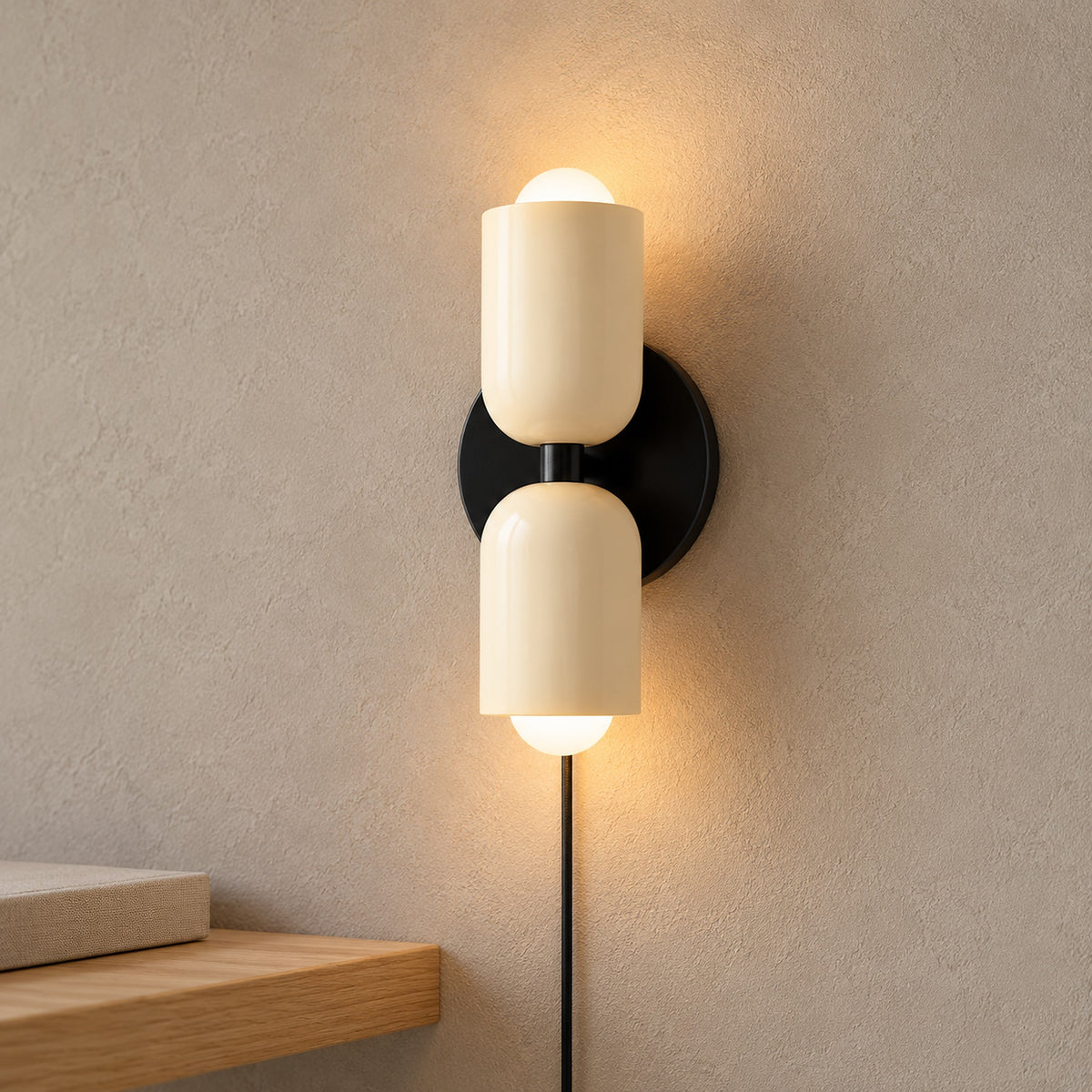 Talomi beige wall sconce showing the lower bulb opening beside a hand in a hallway