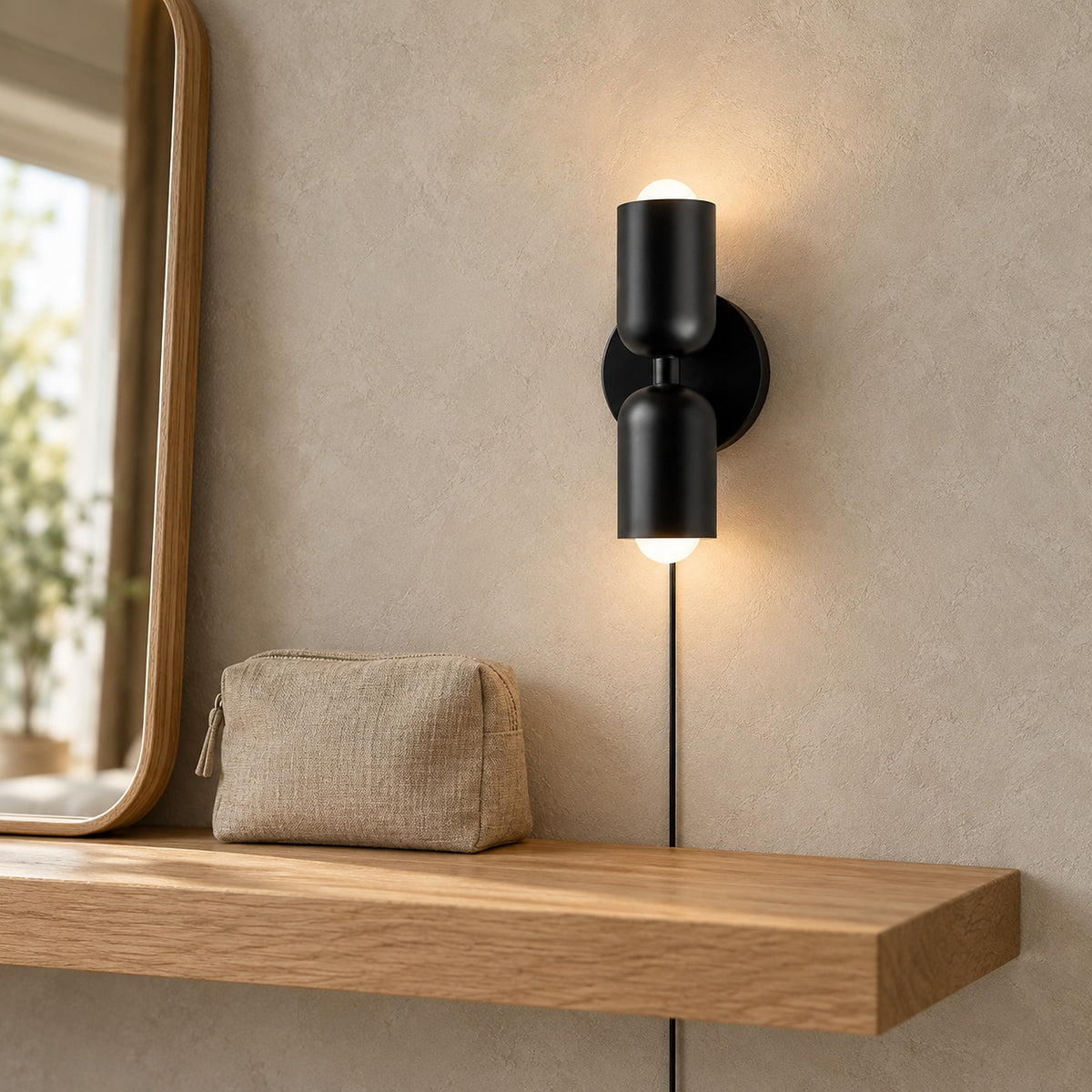 Talomi black bedside wall light glowing beside a dressing room mirror in daylight #color_black