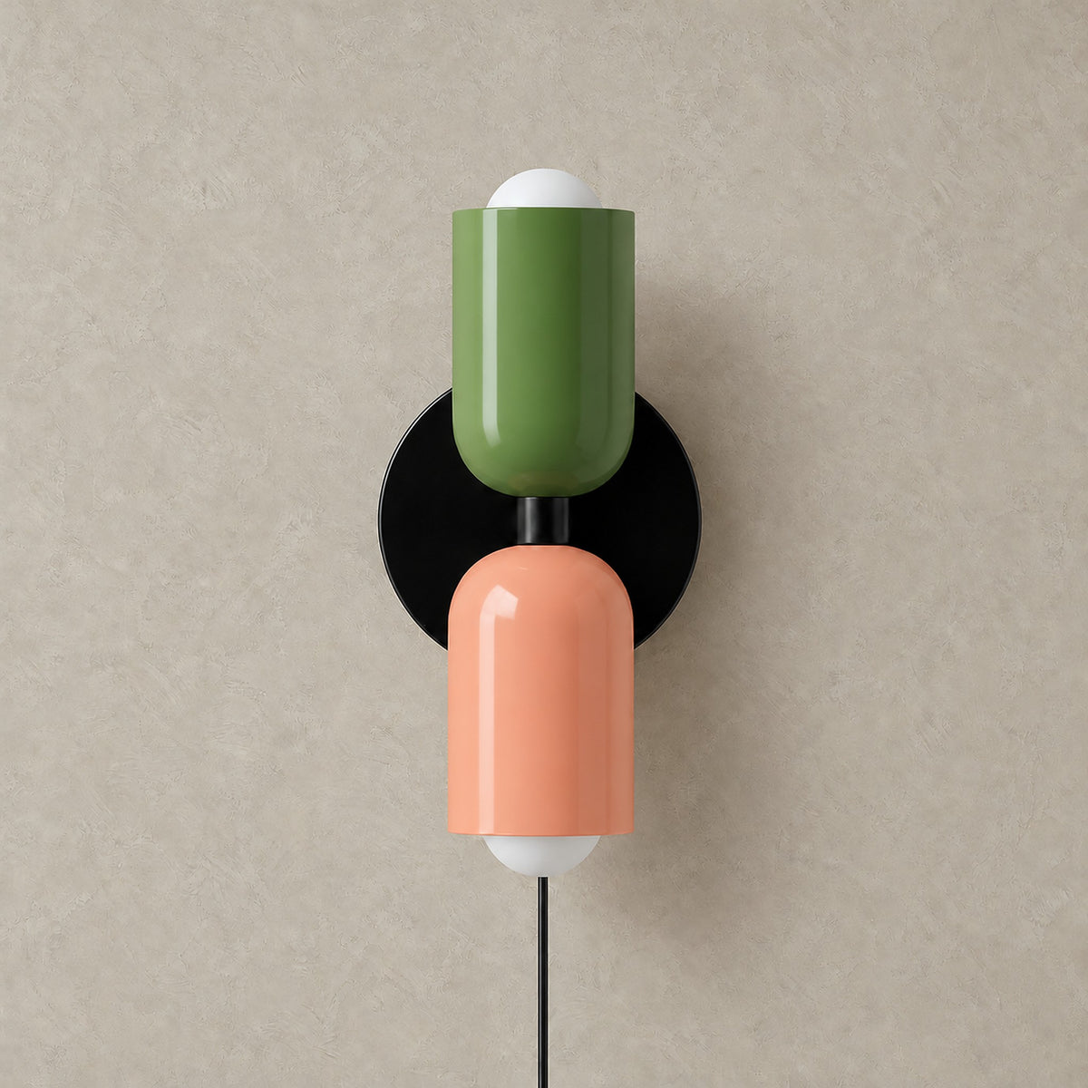 Talomi green and pink wall lamp unlit on a plain backdrop showing its finish #color_green & pink