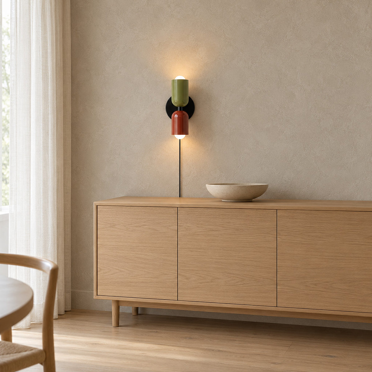 Talomi green and red plug in wall lamp lit above a pale dining sideboard #color_green & red