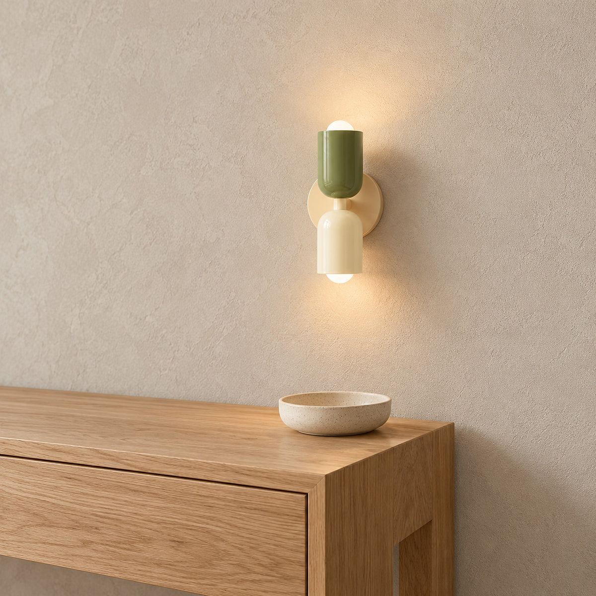 Talomi green and white and beige base wall sconce lit above an entryway console in daylight #color_green & white & beige base