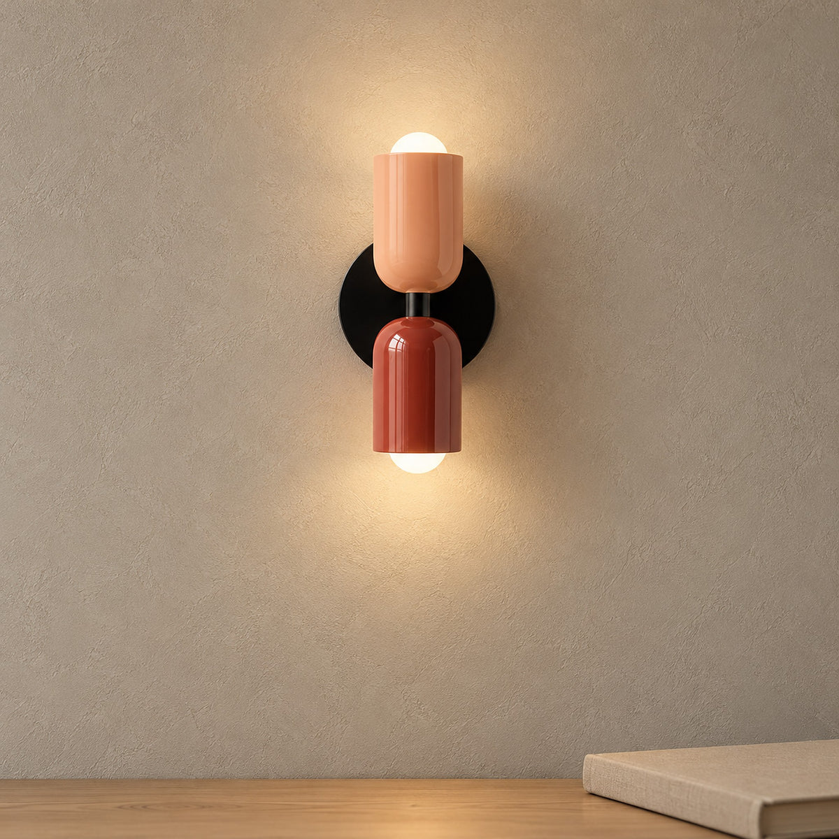 Talomi pink and red plug in wall lamp casting warm light beside a hand in a hallway #color_pink & red