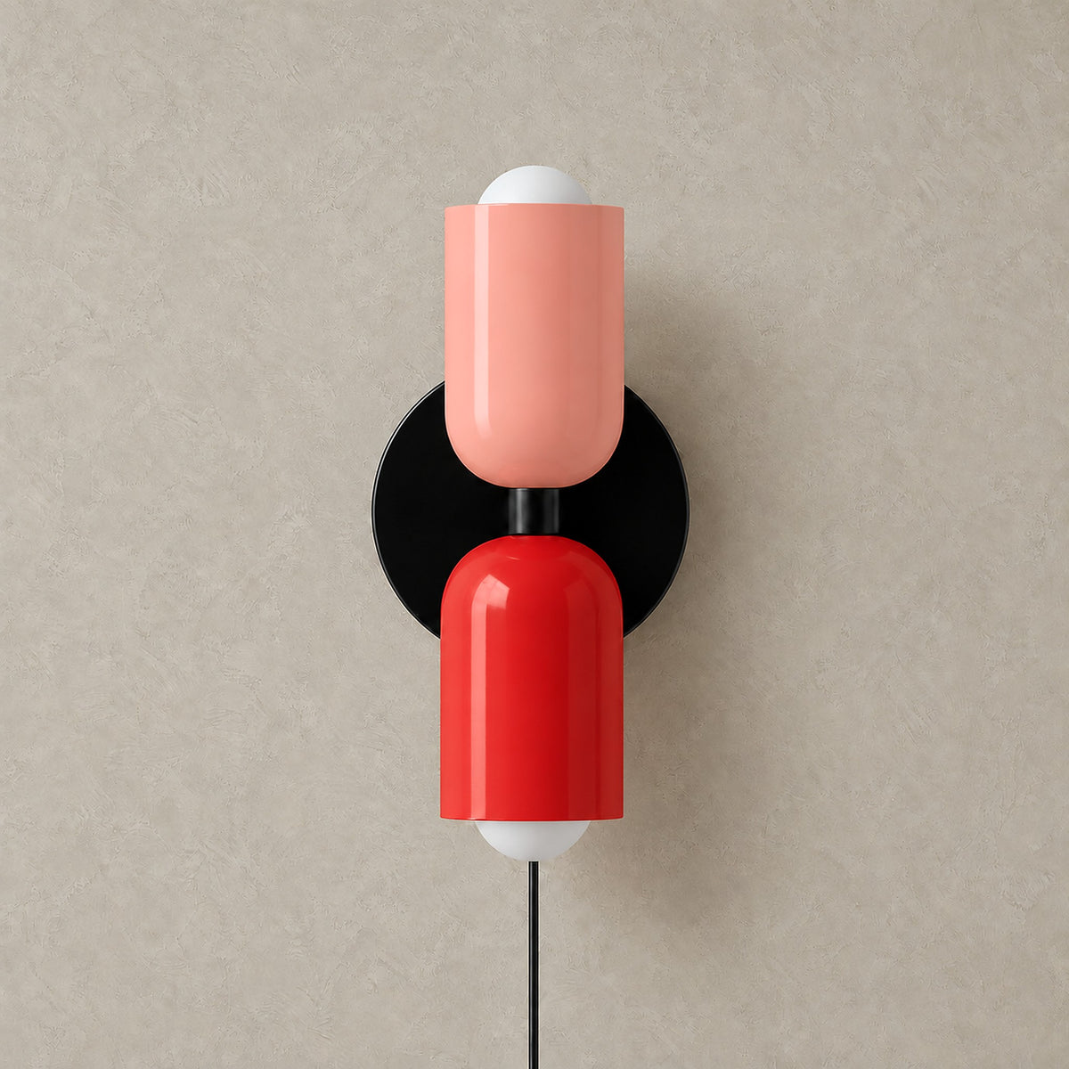 Talomi pink and red wall sconce with a black backplate, unlit on a plain backdrop #color_pink & red