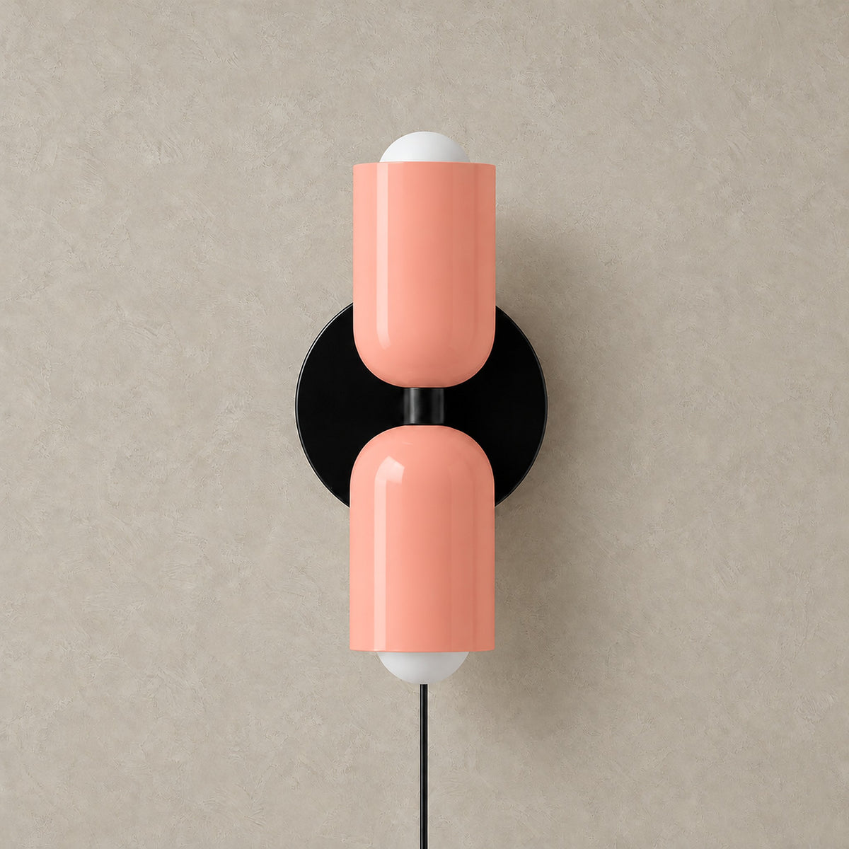 Talomi pink bedside wall light unlit on a plain backdrop showing its single color finish #color_pink