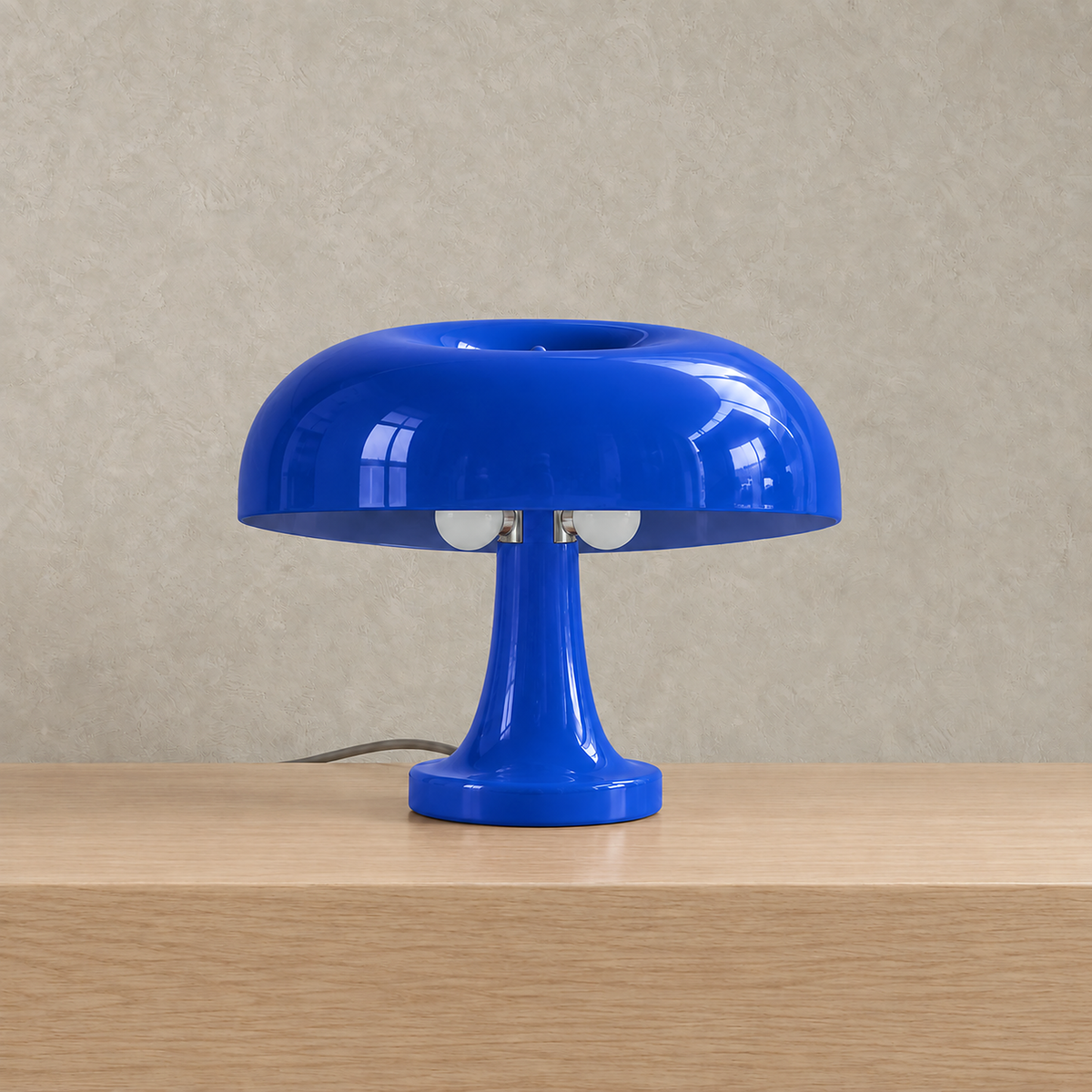 Tamolise mushroom table lamp in glossy blue, unlit against a plain plaster wall #color_blue
