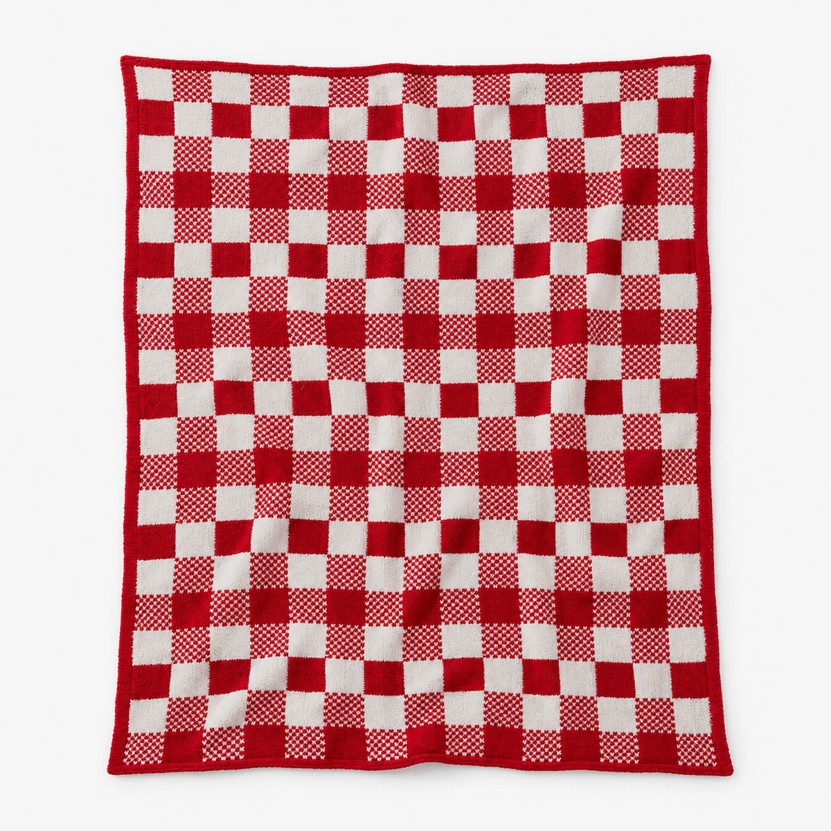 Tamosira red and white knit throw blanket fully open, showing the bold check of solid and patterned squares
