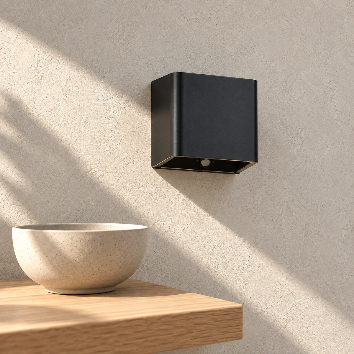 Tanelia black battery operated wall sconce above a dining room corner in direct daylight