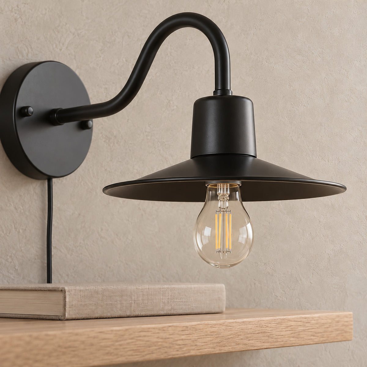 Tarelio black bedside wall light, close view of the metal shade and clear bulb in daylight