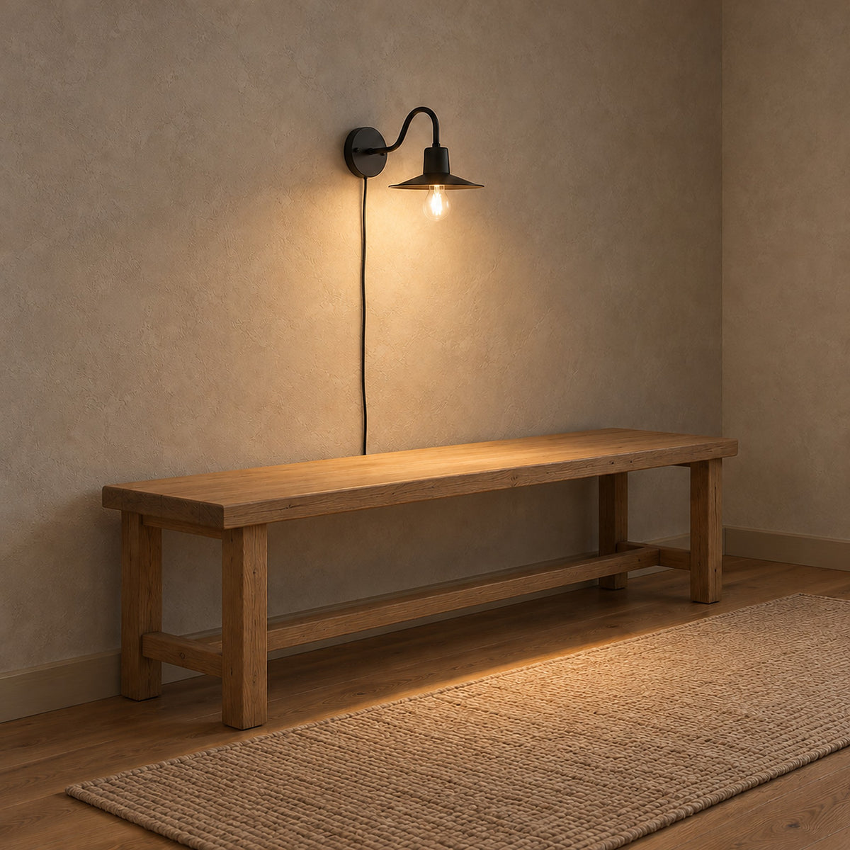 Tarelio black plug in wall lamp lit above a bare entry bench in a hallway