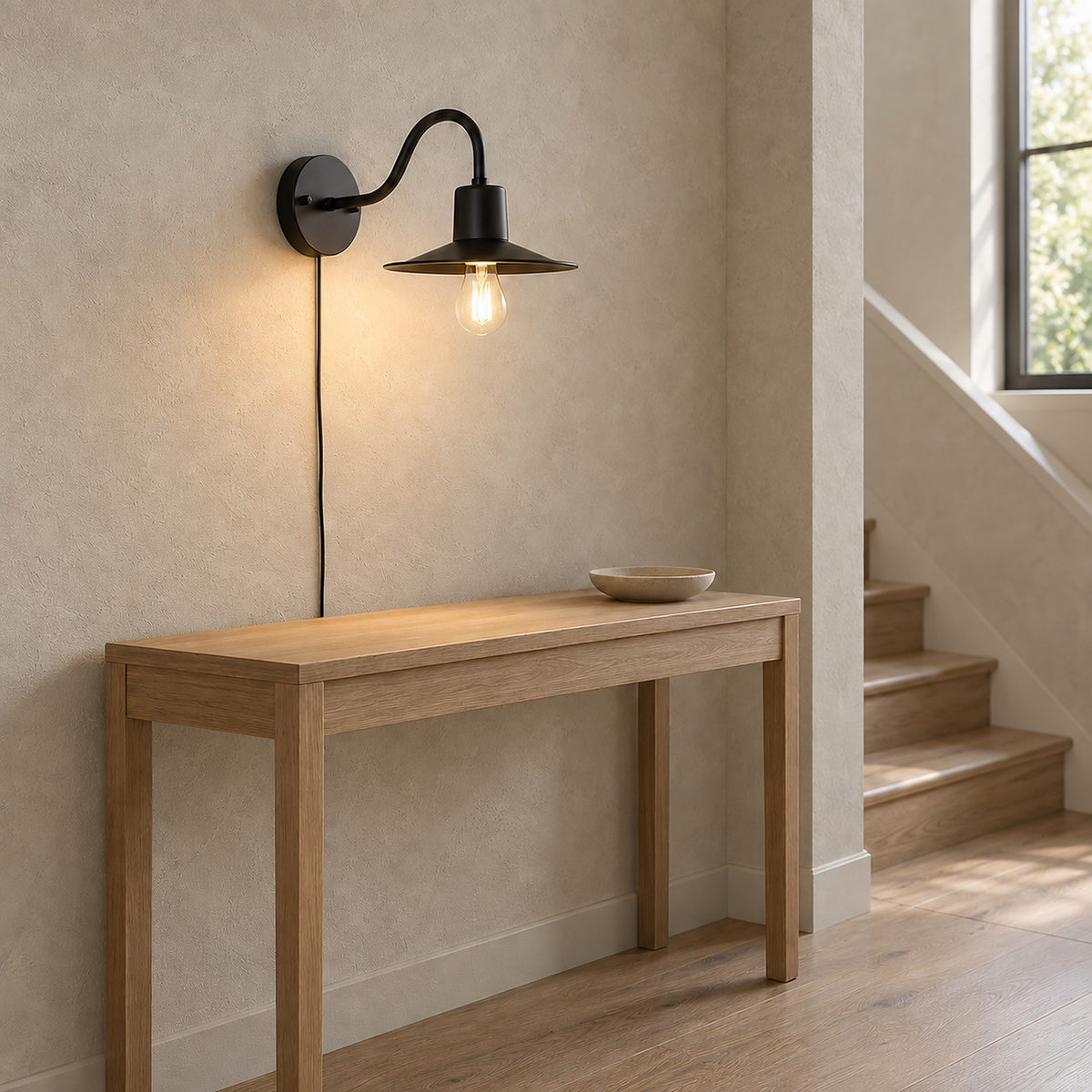 Tarelio black wall light seen from the side, showing the gooseneck arm on a stair landing
