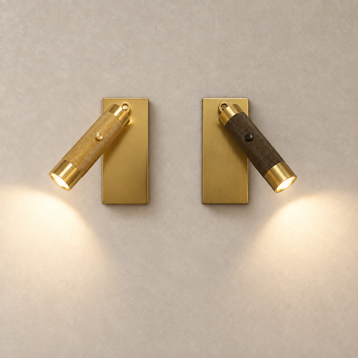 Tavelo gold and bronze LED wall sconce pair lit side by side against plain plaster