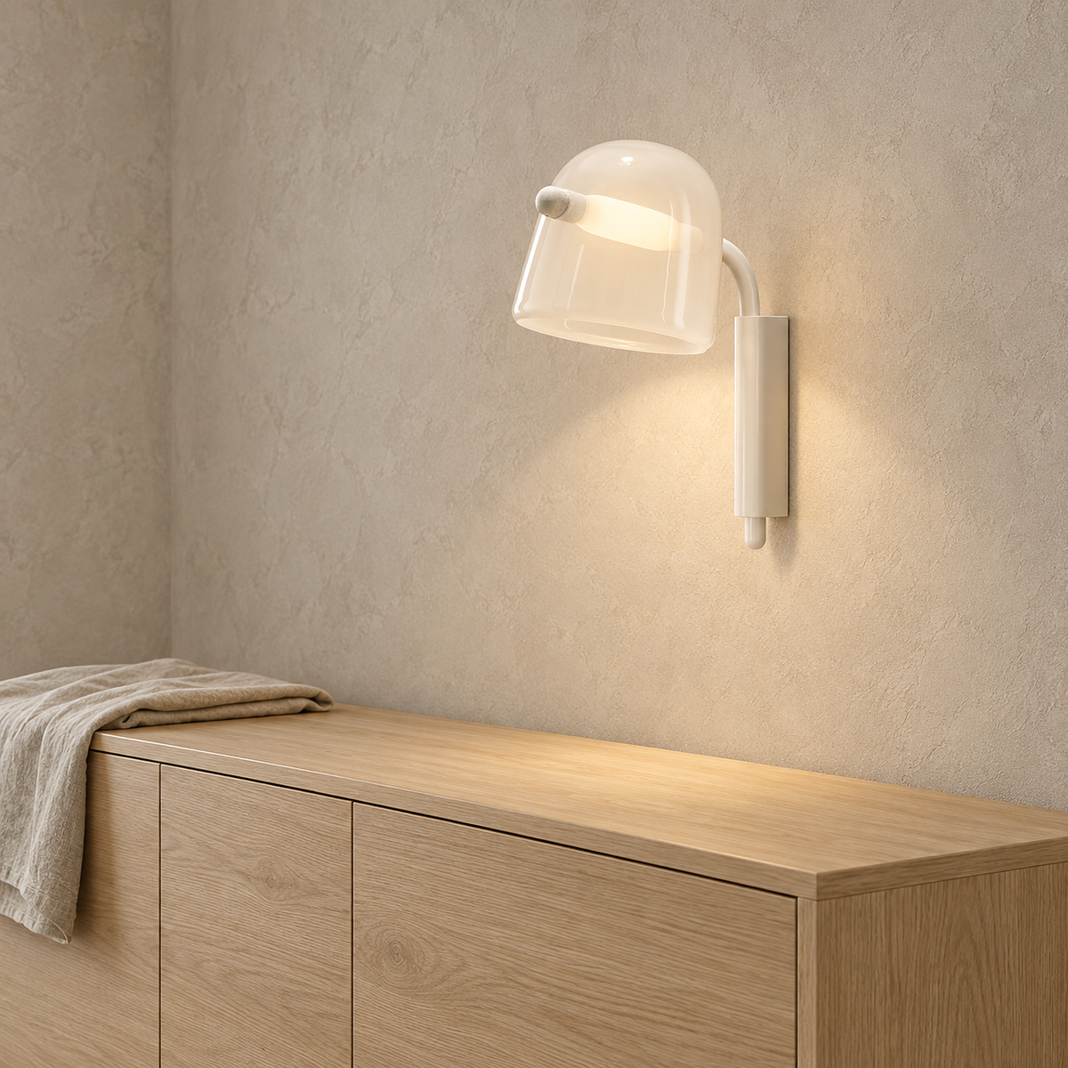 Tavessi white glass wall sconce glowing on a dining room wall in daylight #color_white