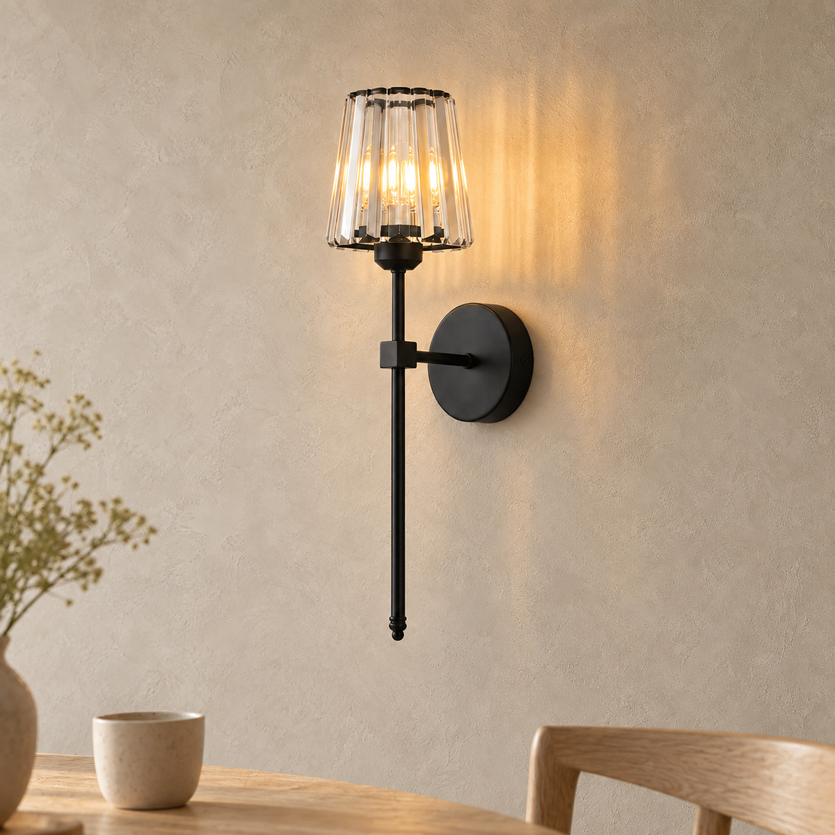 Tavirelo black wireless wall light glowing beside a dining table in daylight