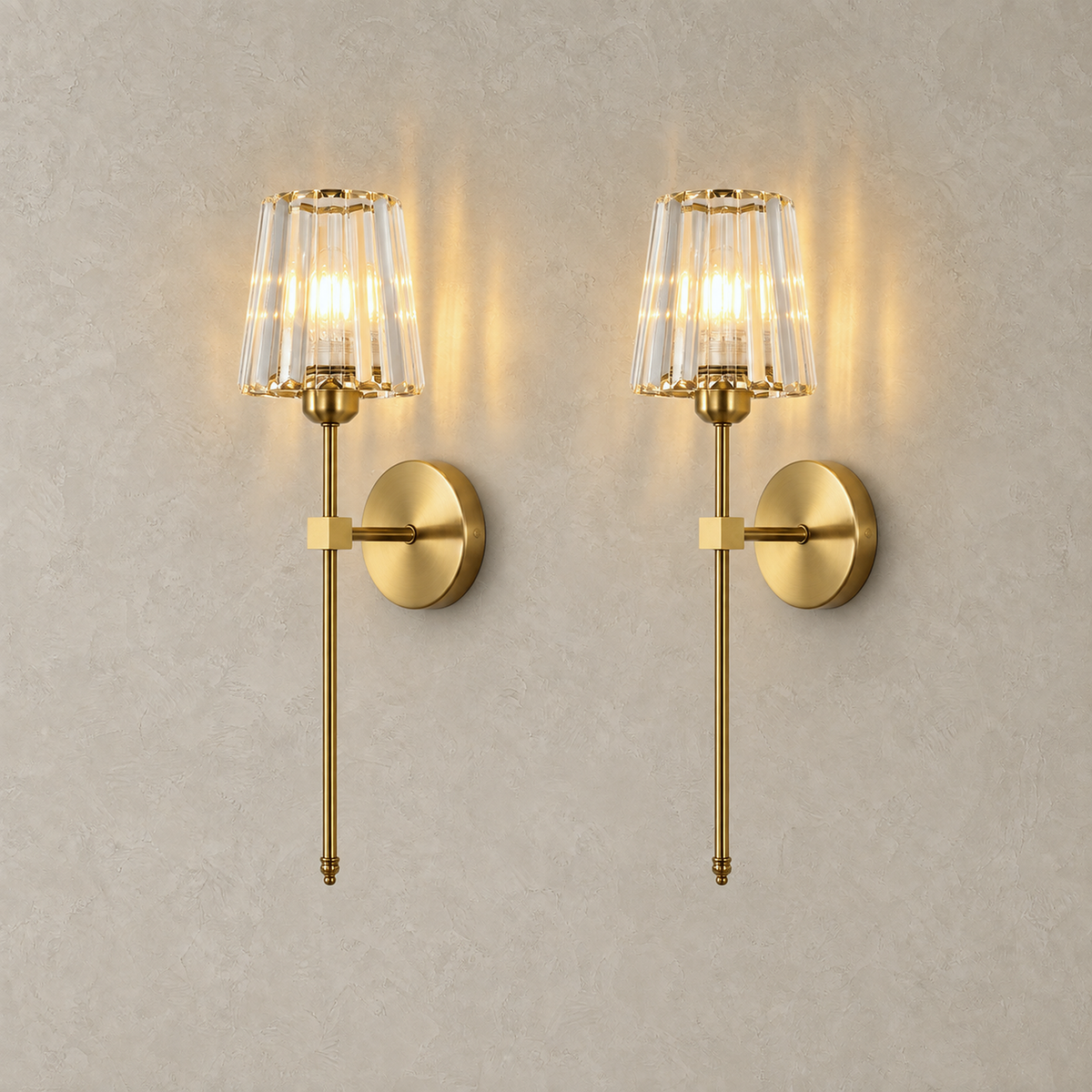 Tavirelo gold battery operated wall sconce set of two lit against a plain backdrop #color_gold