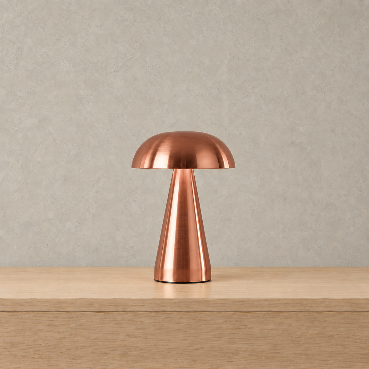 Telirra copper rechargeable table lamp unlit against warm greige plaster #color_copper