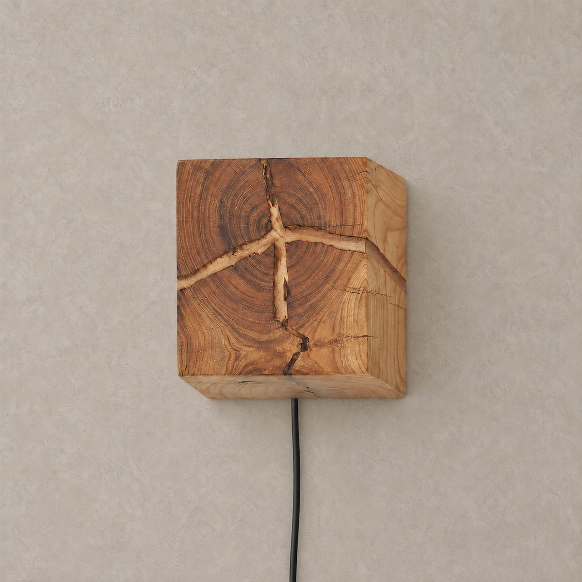 Temalio plug in led wall sconce in natural wood with its power cord running down the wall