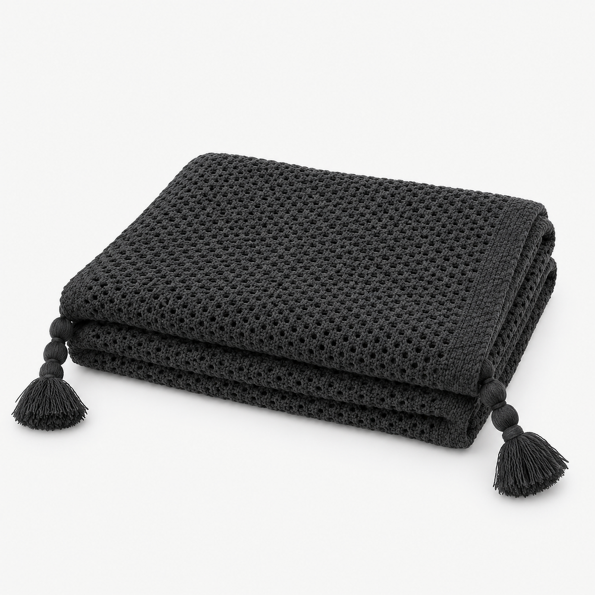 Tevolin gray tassel throw blanket loosely folded with matching yarn tassels