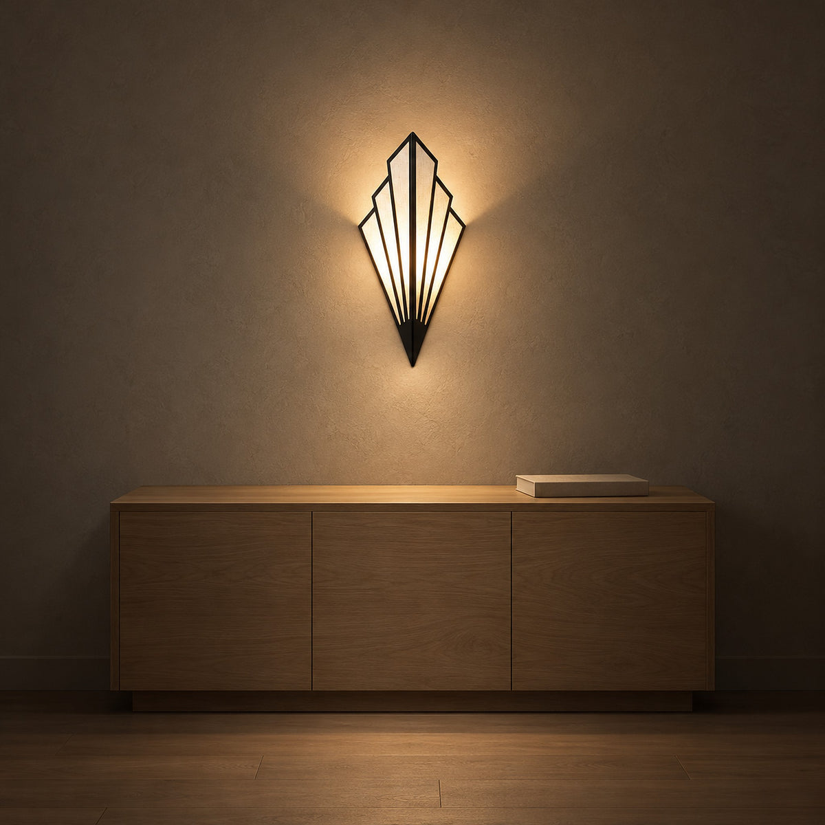 Ticorena Black fan shaped wall lamp casting warm light above a wooden sideboard with a book on top