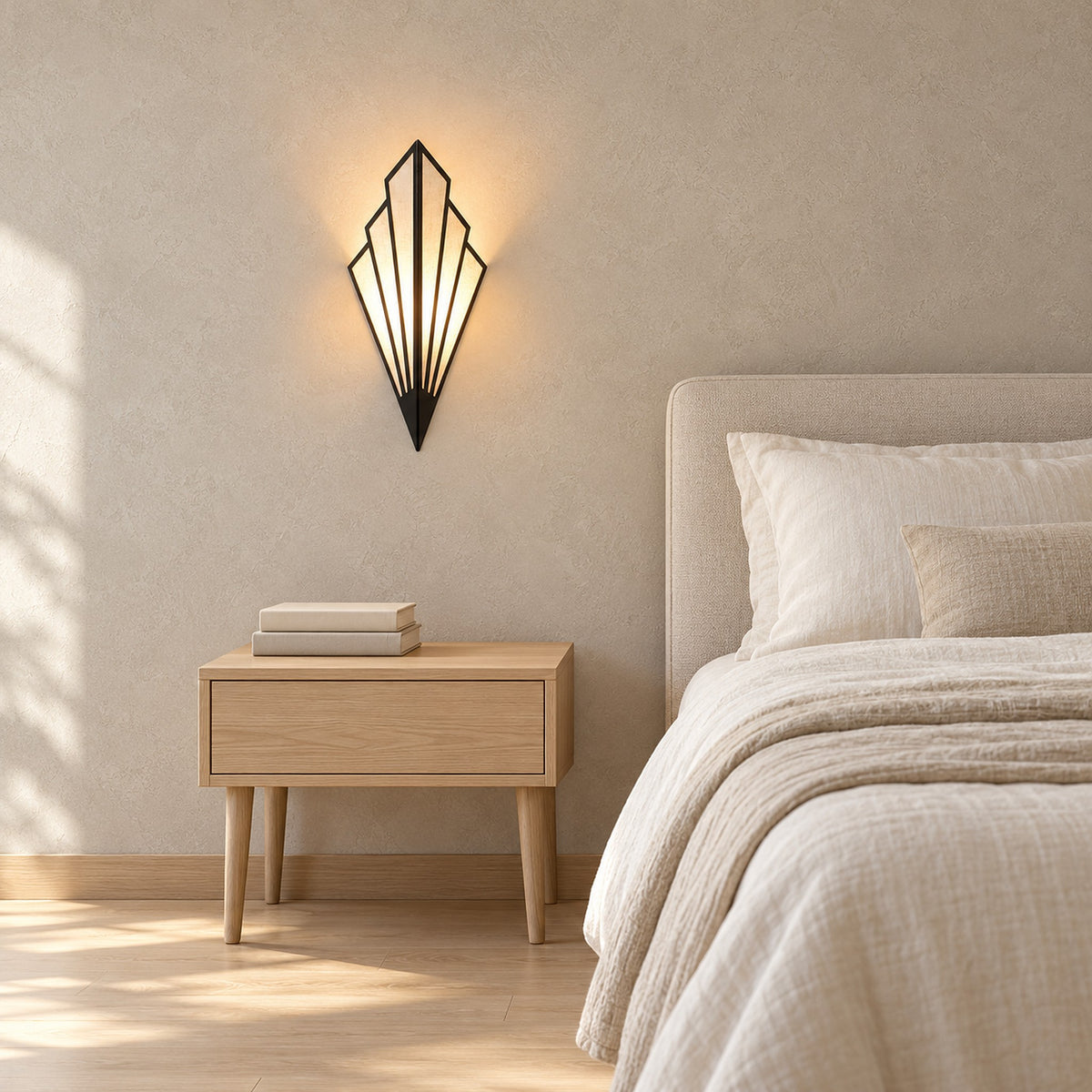 Ticorena Black fan shaped wall sconce glowing warmly beside a bed above a wooden nightstand with two books