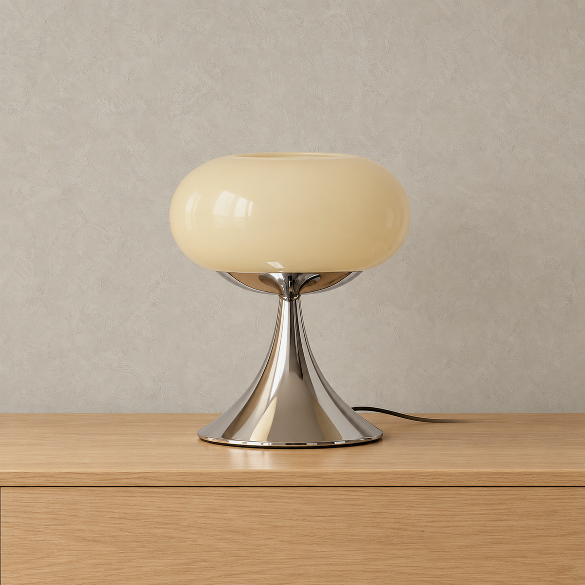 Tilvara stained glass table lamp in beige, unlit on a pale surface with its metal stem and base