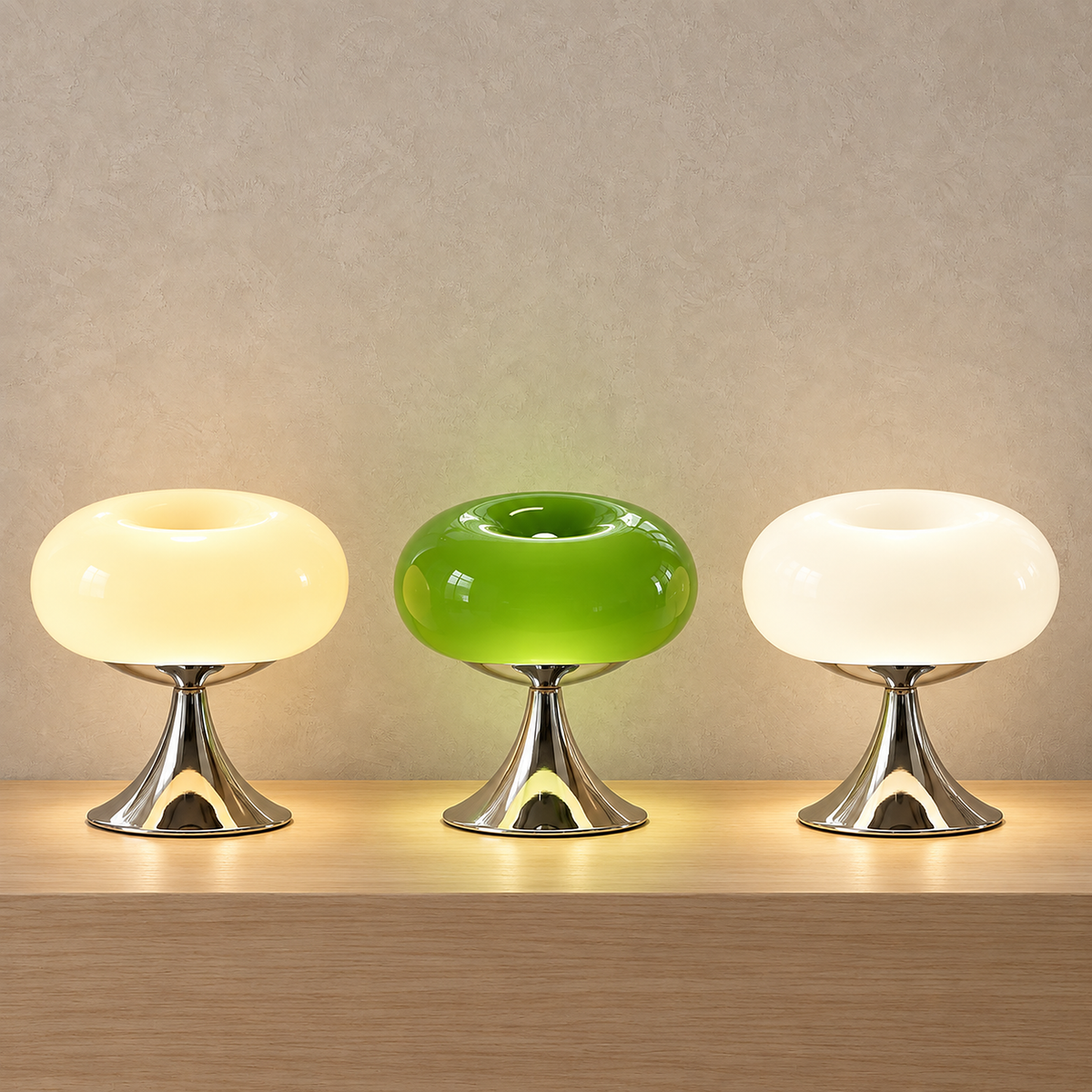 Tilvara table lamp in beige, green and white, all three glowing side by side