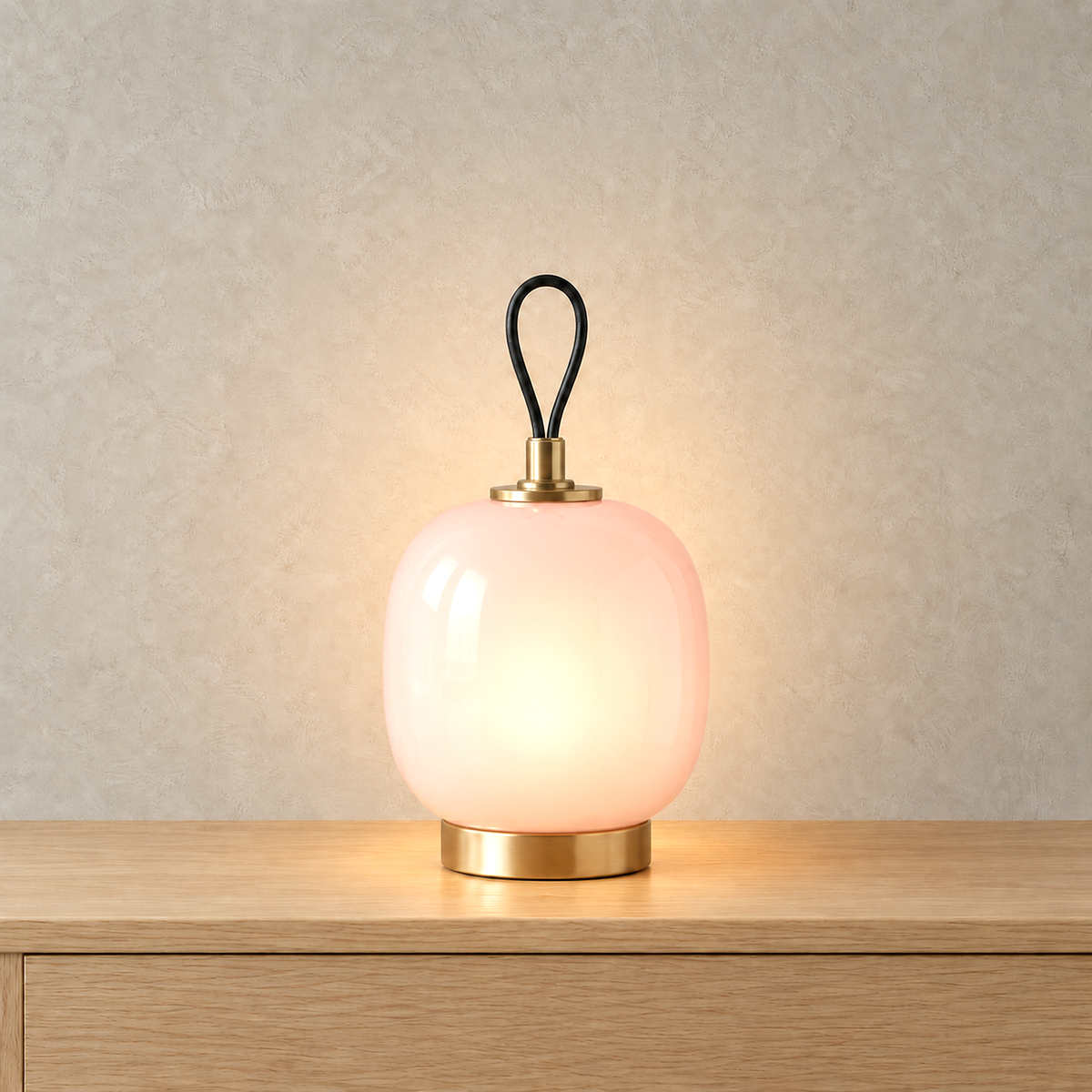 Timarelo cream pink table lamp with its glass softly lit from inside, so you see a gentle glow and no bulb