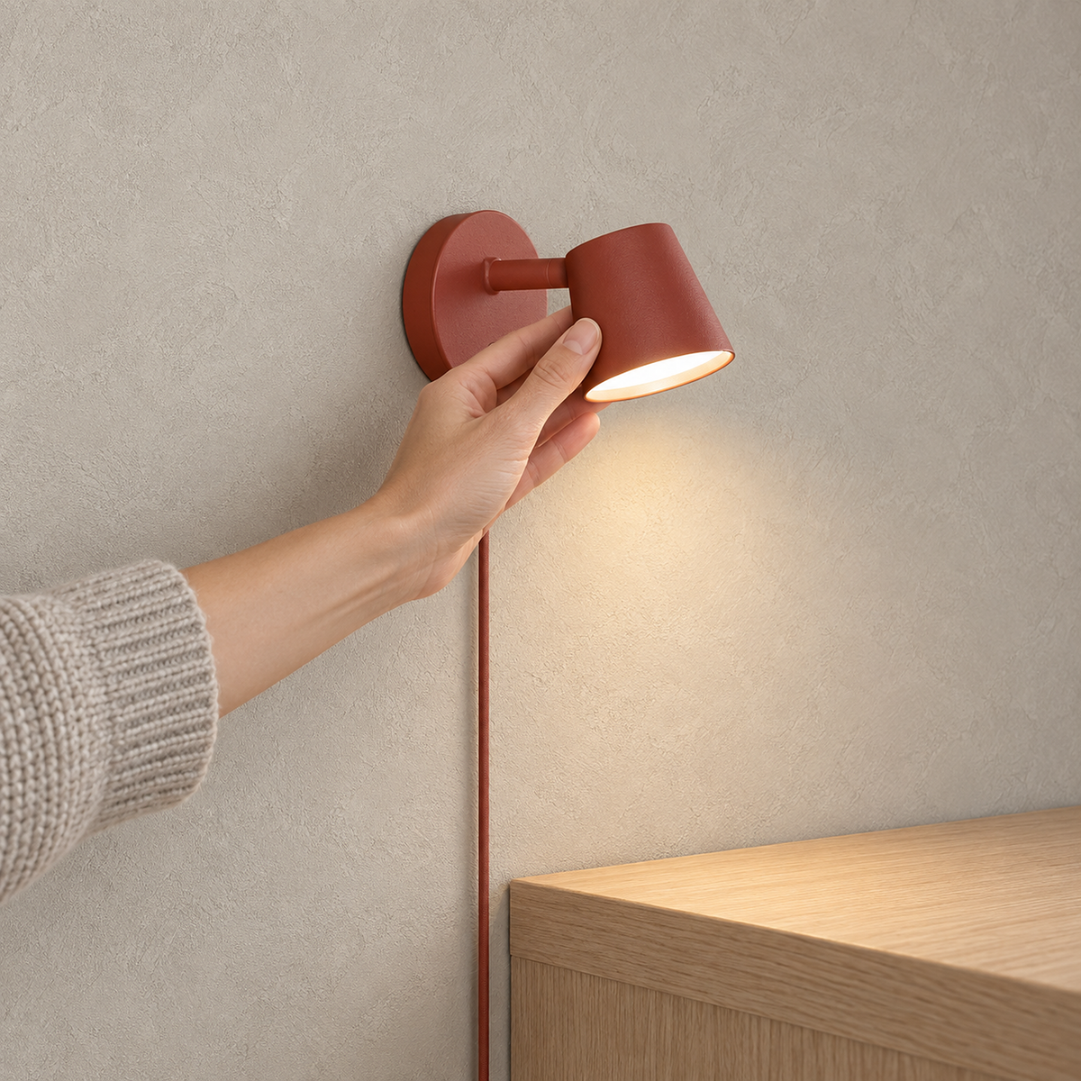 Tisello red LED wall sconce glowing above a console in an entryway corner #color_red