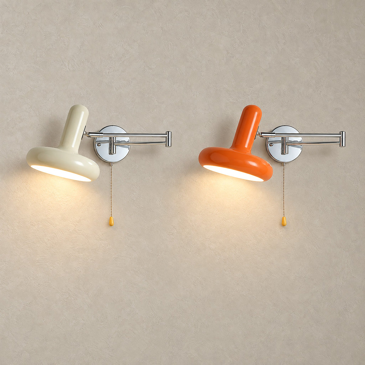 Tivenola bedside wall light in cream and orange, two lit side by side on plaster