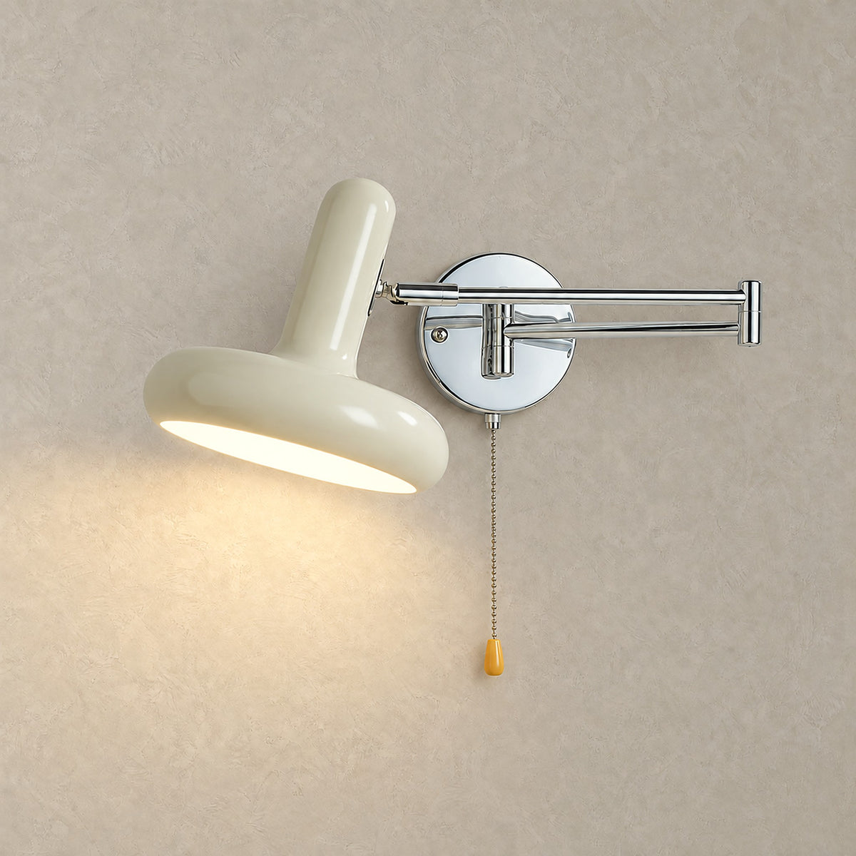 Tivenola cream wall sconce switched on, casting soft warm white light across a plaster wall