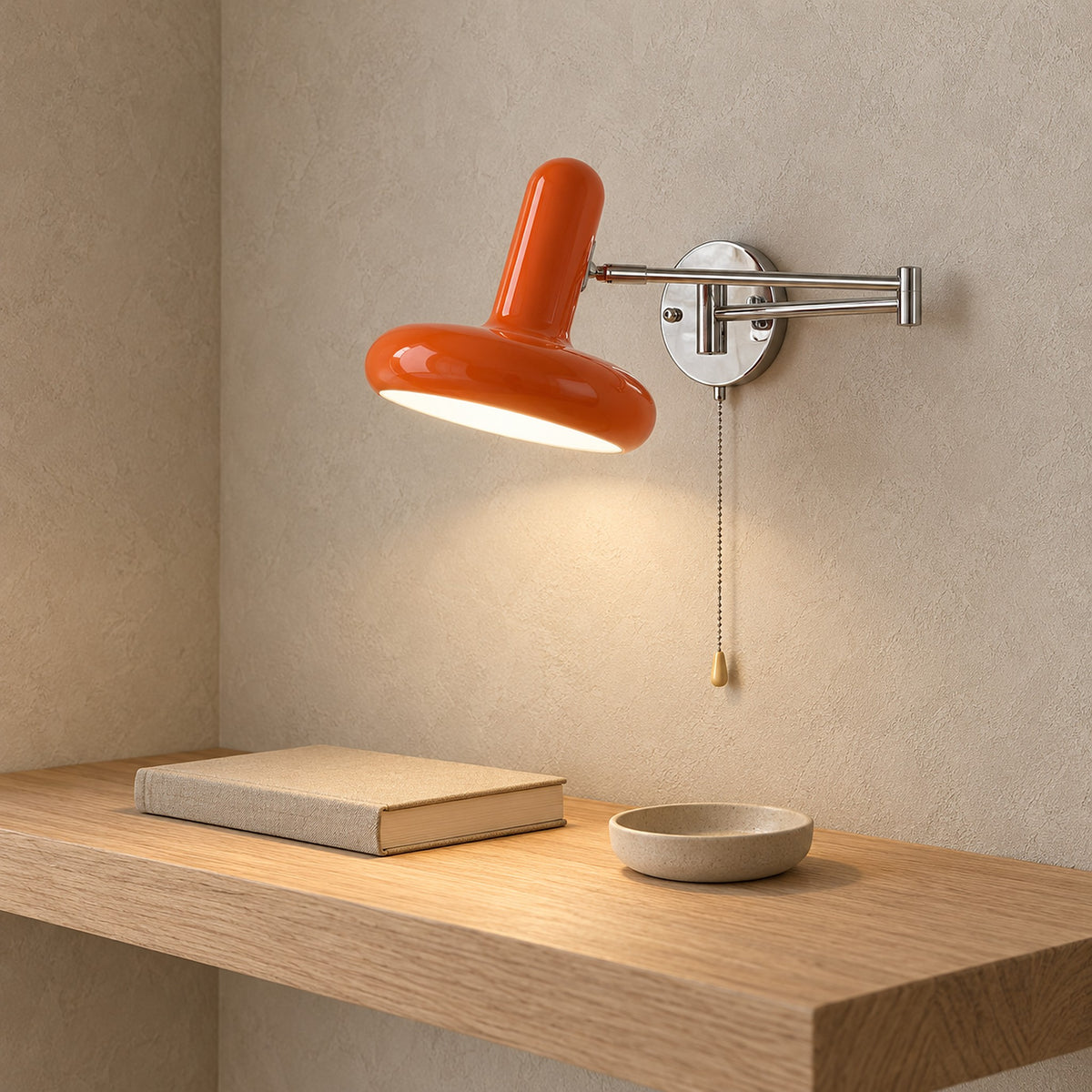 Tivenola orange wall sconce lit above a shelf, adding color to a dining room correspondence nook #color_orange